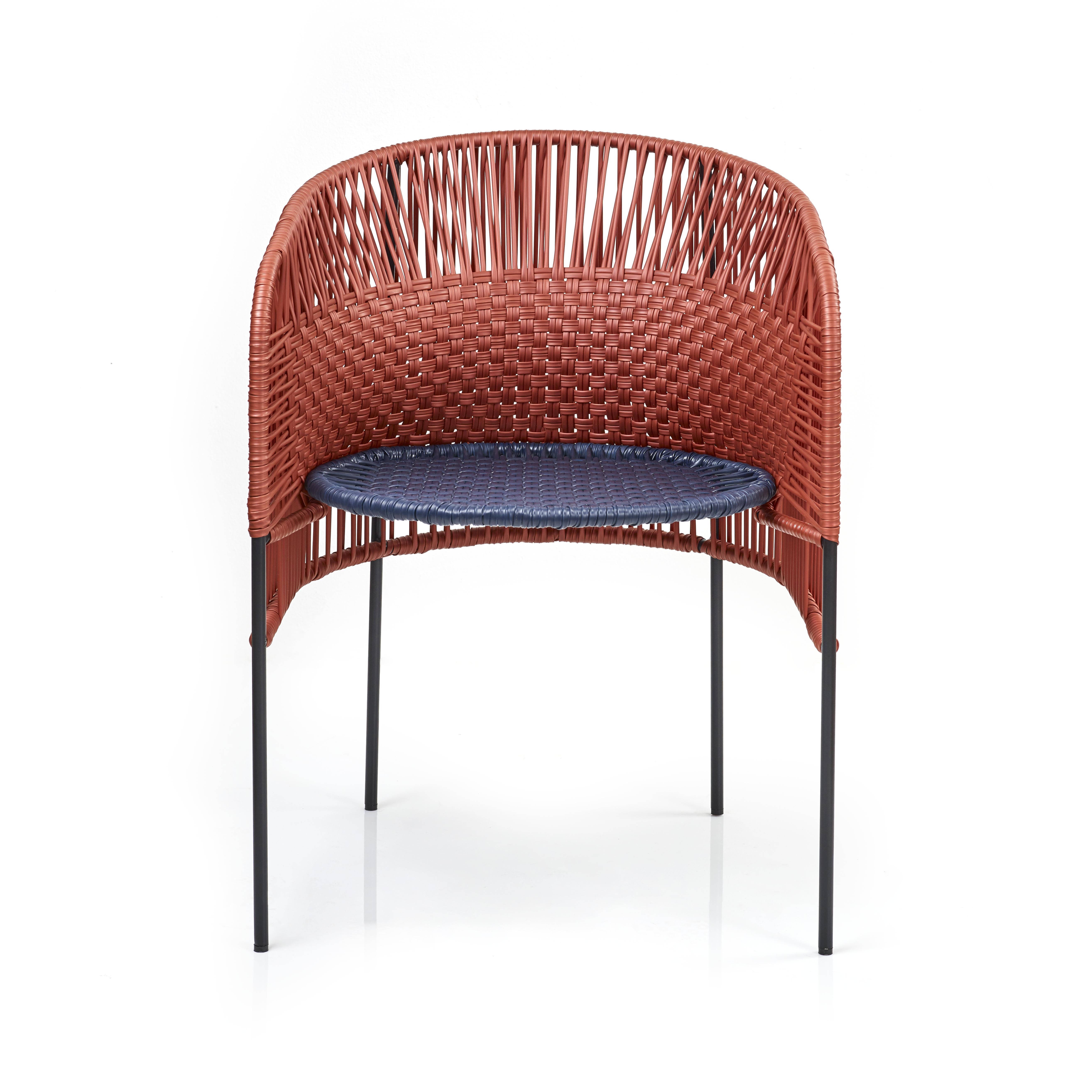 Orange Caribe chic dining chair by Sebastian Herkner
Materials: Galvanized and powder-coated tubular steel. PVC strings are made from recycled plastic.
Technique: Made from recycled plastic and weaved by local craftspeople in Colombia. 
Dimensions: