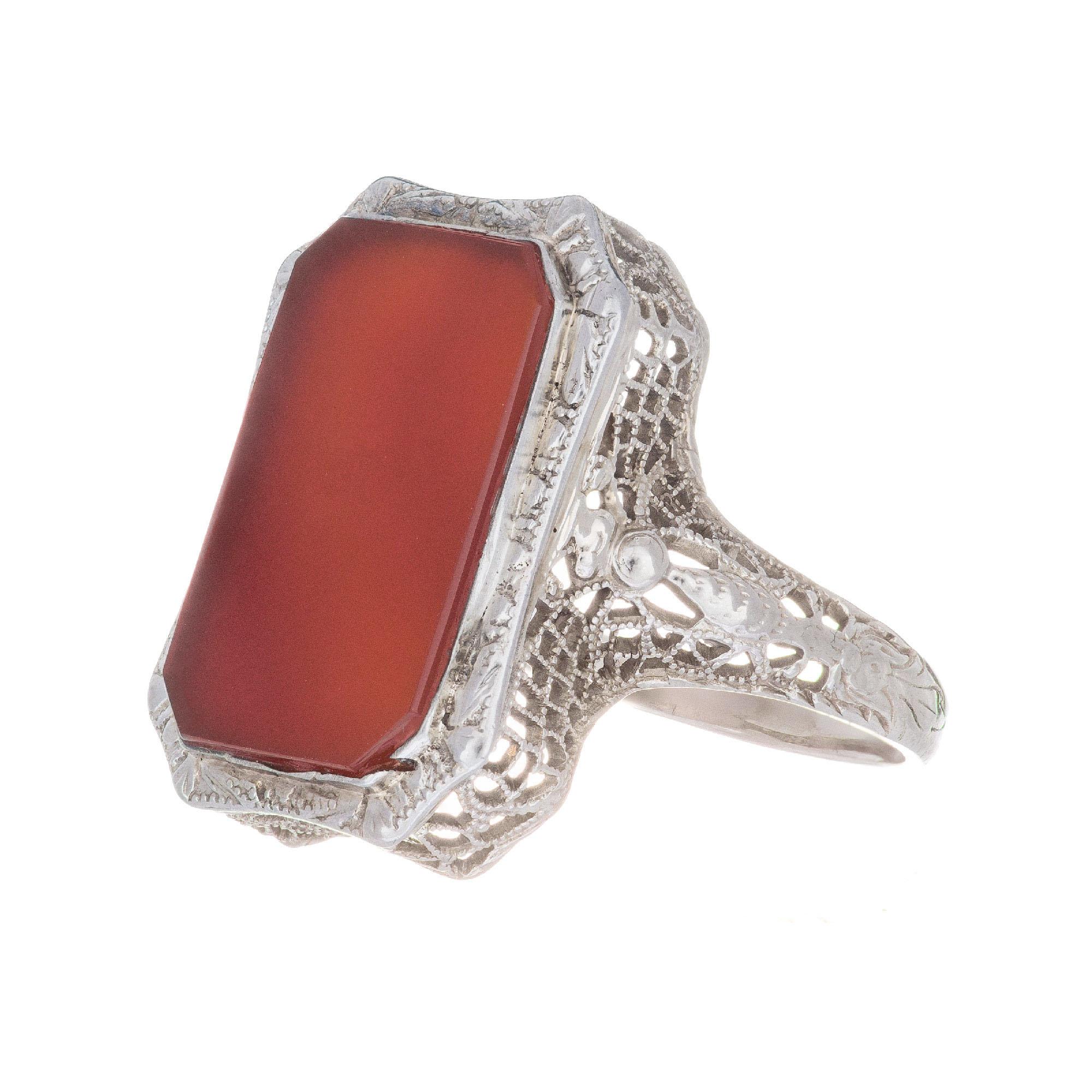 Estate 1930's translucent rectangular carnelian center stone in a 14k white gold filigree setting. 

1 cut cornered rectangular orange carnelian 
Size 7 and sizable
14k white gold 
Stamped: 14k
3.7 grams
Width at top: 19.6mm
Height at top: