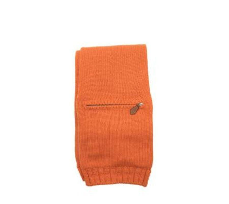 Hermes Orange Cashmere Zip Pocket Scarf
 
 - Soft cashmere, mid-weight yarn
 - H ribbed ends
 - One functional zip pocket 
 
 Materials: 
 100% Cashmere 
 
 Made in Scotland 
 Dry clean only 
 
 9.5/10 excellent
 
 PLEASE NOTE, THESE ITEMS ARE