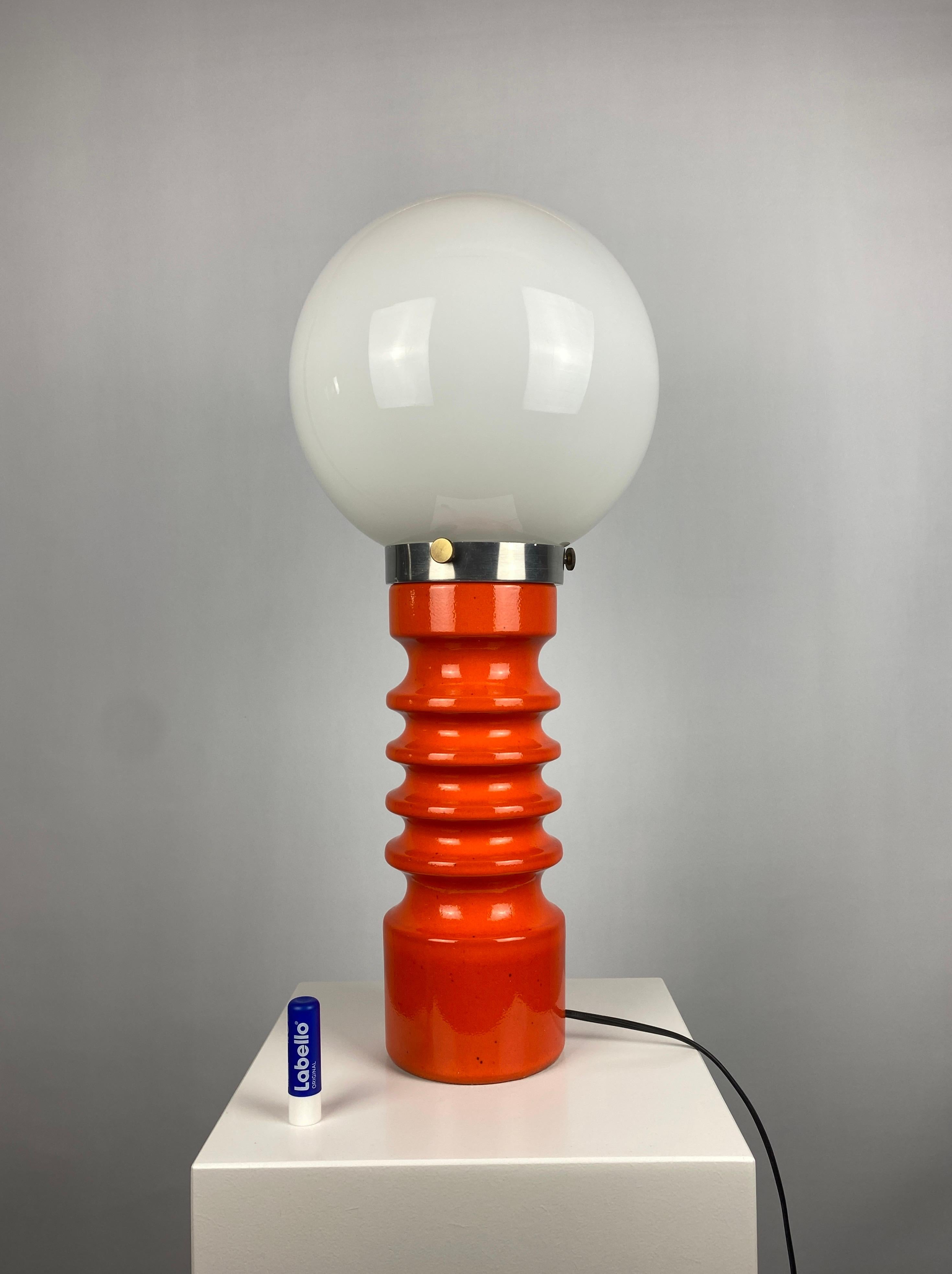 Large orange ceramic table lamp designed by Cari Zalloni for Steuler in the 1970's manufactured in West Germany. 

The glass globe is hold in place on the metal part with three screws. Has a space age feel to it. 

Marked on the bottom: W.