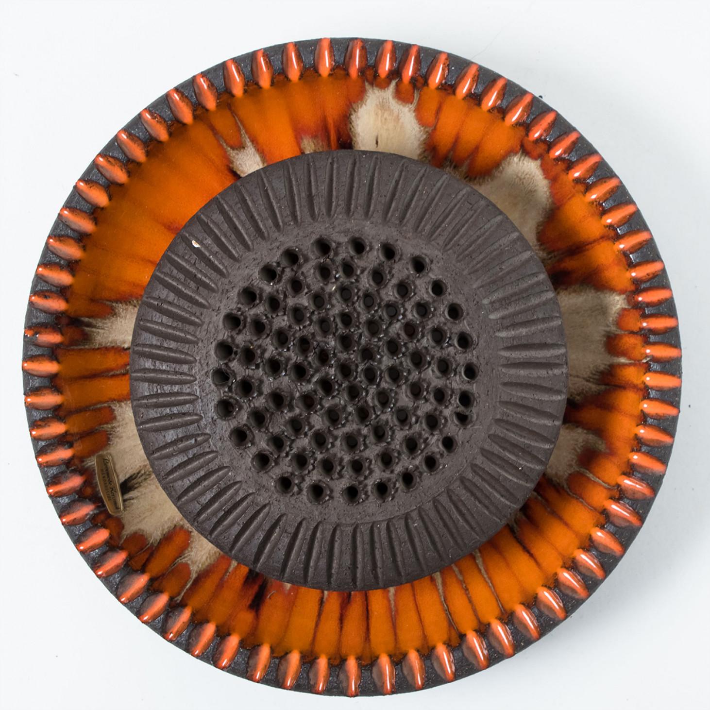 Spectacular circular ceramic wall light, with beautiful orange and brown accents. Manufactured in Denmark in the 1970s.

Labelled by Løvemose, in excellent condition.  Løvemose was a pottery in the town of Kædeby on the island of Langeland in