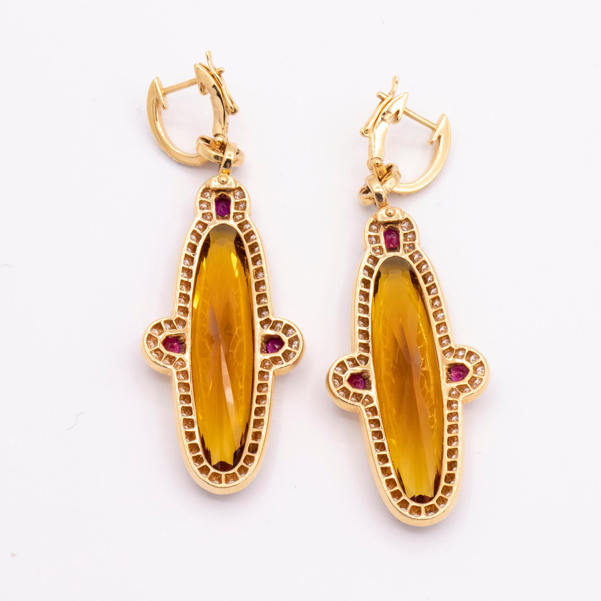 From Hamilton's Gemstone Collection, handmade drop earrings set in 18k rose gold with stunning faceted orange citrine weighing 26.84cts and rubies weighing .74cts. Framed by round brilliant diamonds. The length is 2.25