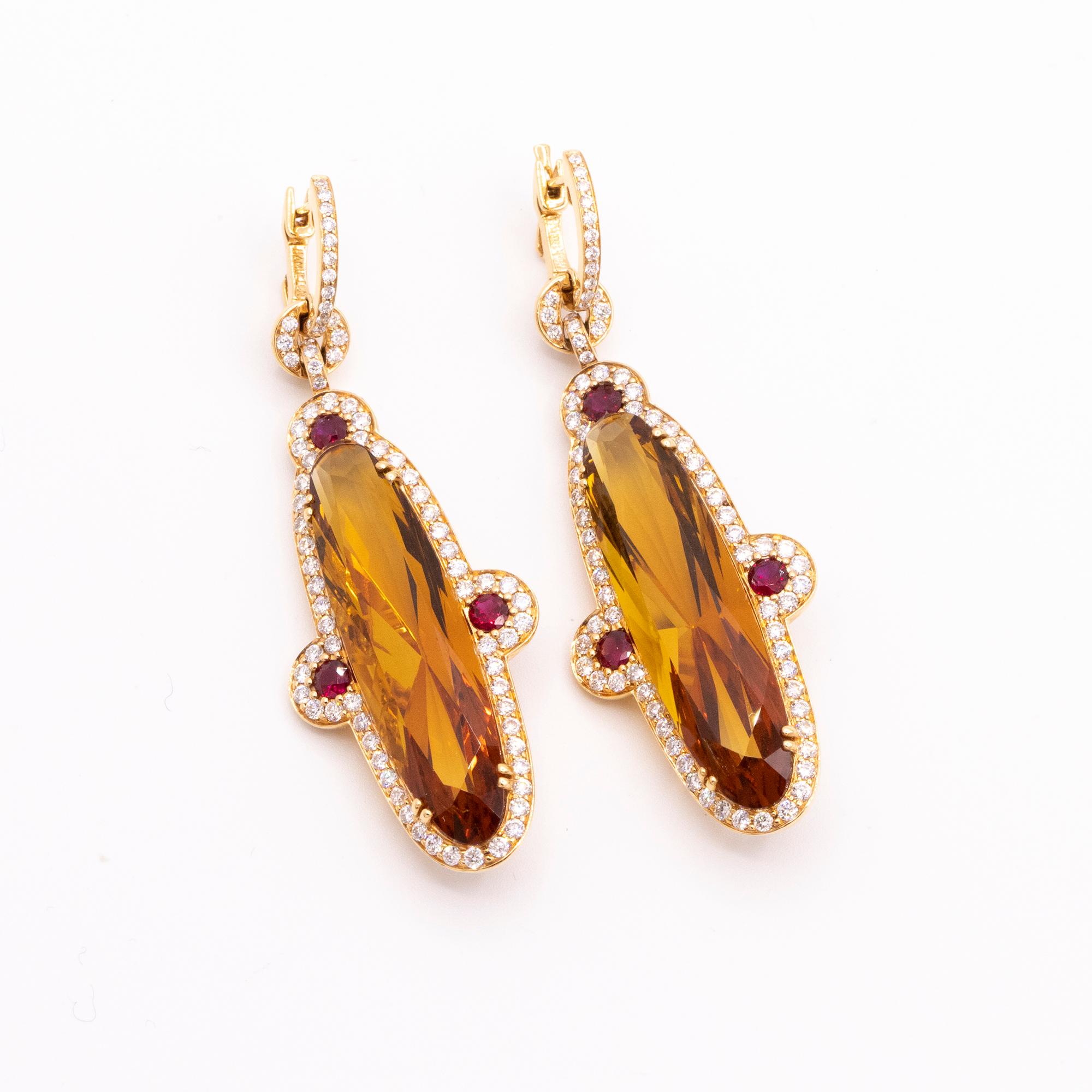 From Hamilton's Gemstone Collection, handmade drop earrings set in 18k white gold with orange citrines, rubies and diamonds. The citrines weigh 26.84ctw, the 6 rubies weigh .74ctw and 160 round brilliant diamonds weigh 1.97ctw. 2 1/4