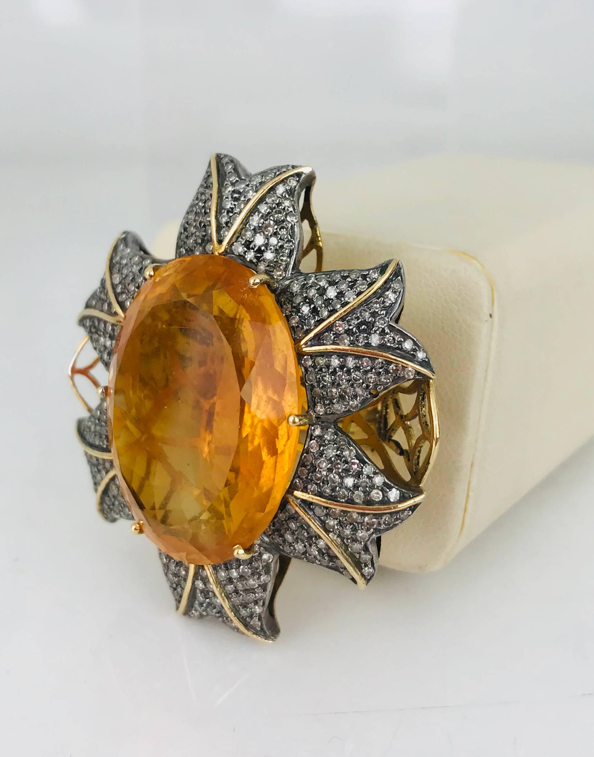 14 karat yellow gold diamond and Orange Quartz, Edwardian ring. The center is a 45 carat orange Quartz and is accented by approximately 1.50 carats of single-cut diamonds in a whimsical style, flamboyant setting. 

The large Quartz measures 26.71 x