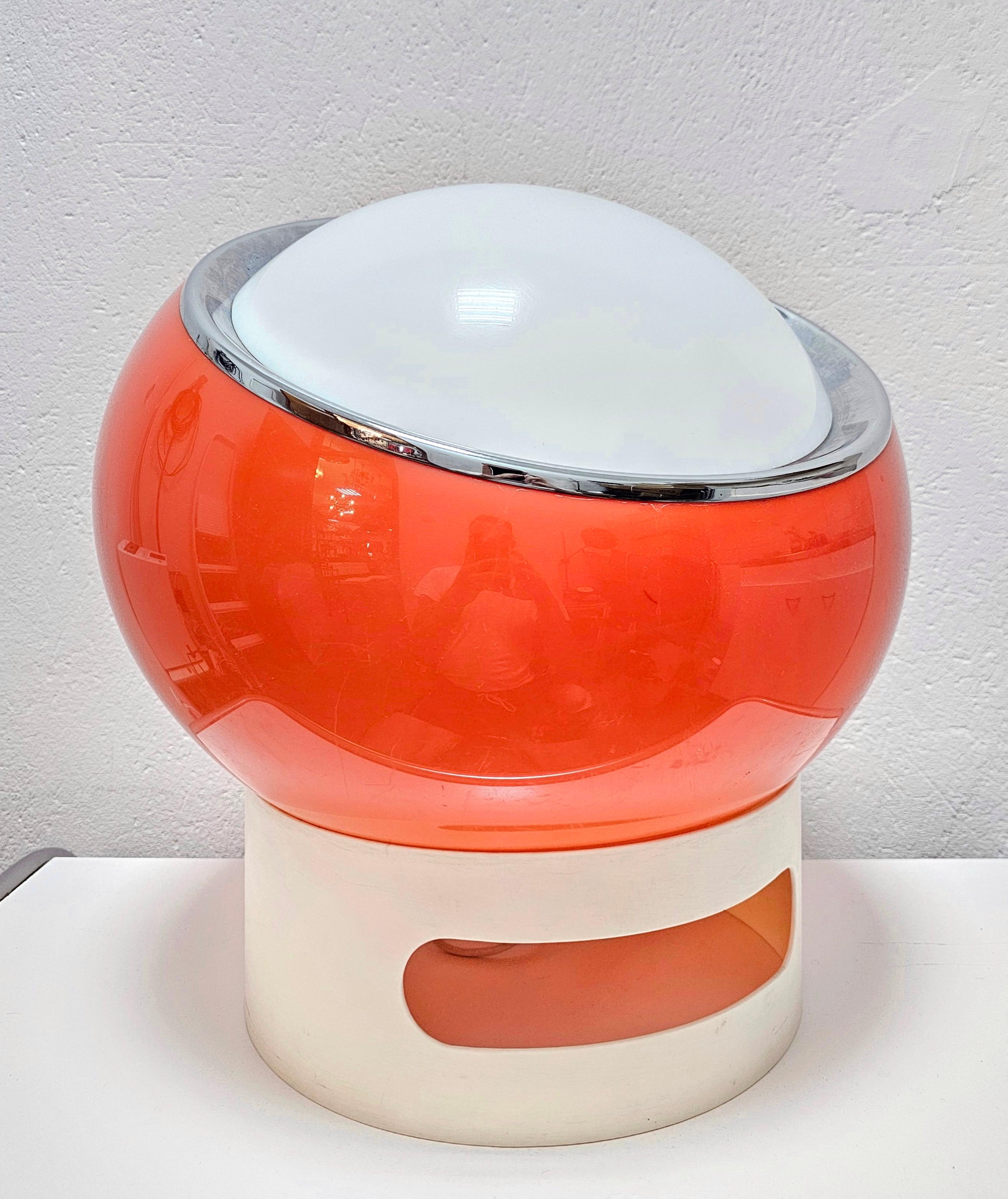 This listing features a very rare Clan floor lamp by Guzzini, designed by Studio 6G for Meblo. It was manufactured in 1970s and it features a large acrylic shade in orange, with the plastic stand. 

Very good vintage condition with barely any sign