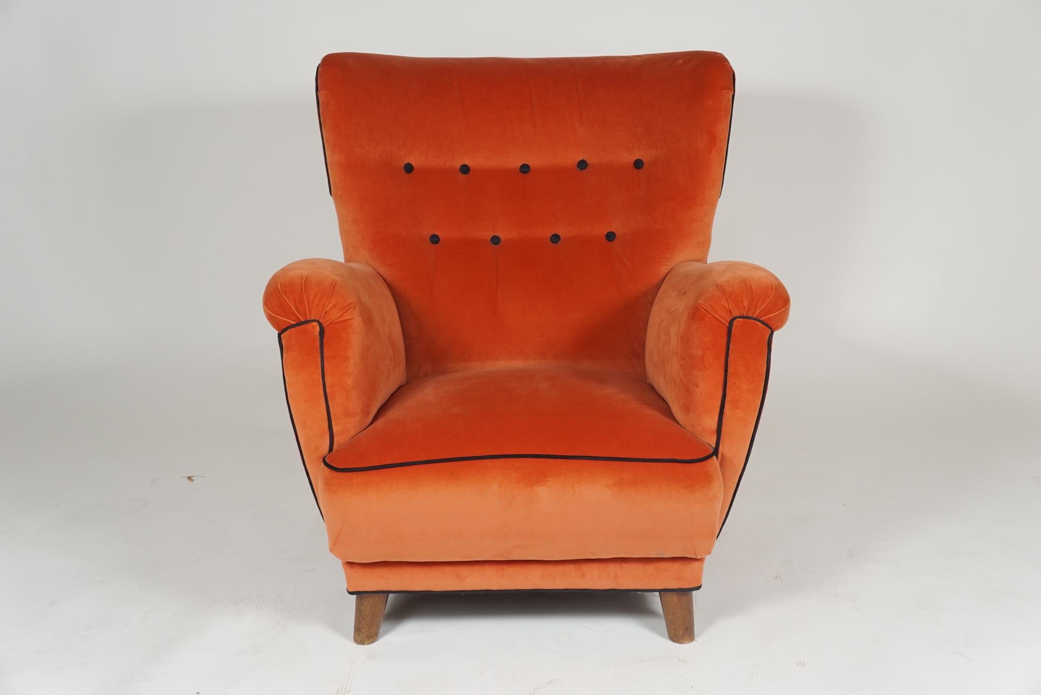 Danish 1940s large-scale club chair upholstered in orange velvet with black trim and button accents. Really comfortable.
 