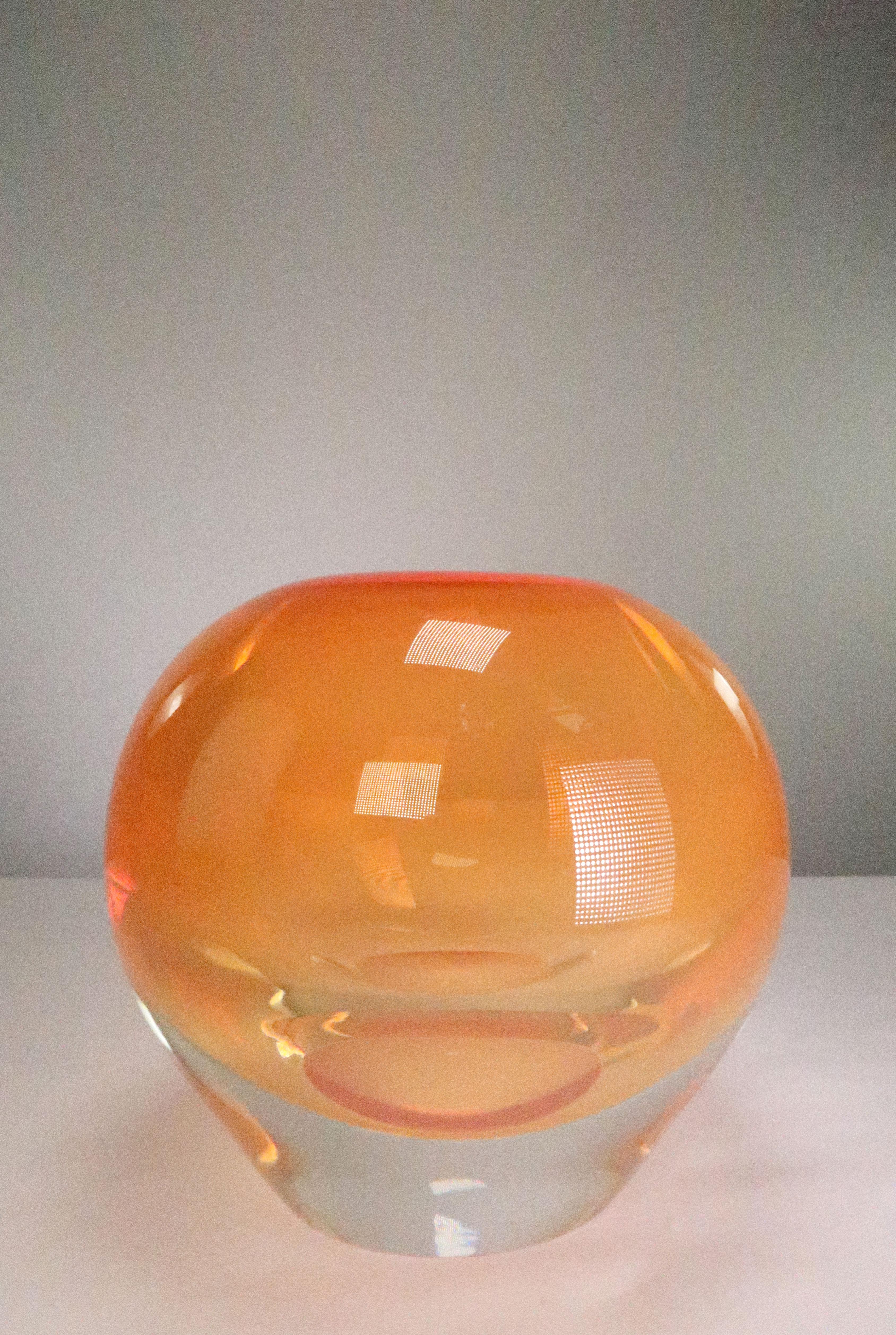 Unique Danish Mid-Century Modern art glass vase in solid and very heavy orange glass encased in clear glass. Round shape with solid orange top and clear base. Extraordinary mouth blown by Danish glass artist at Holmegaard in the 1960s. Manufactured