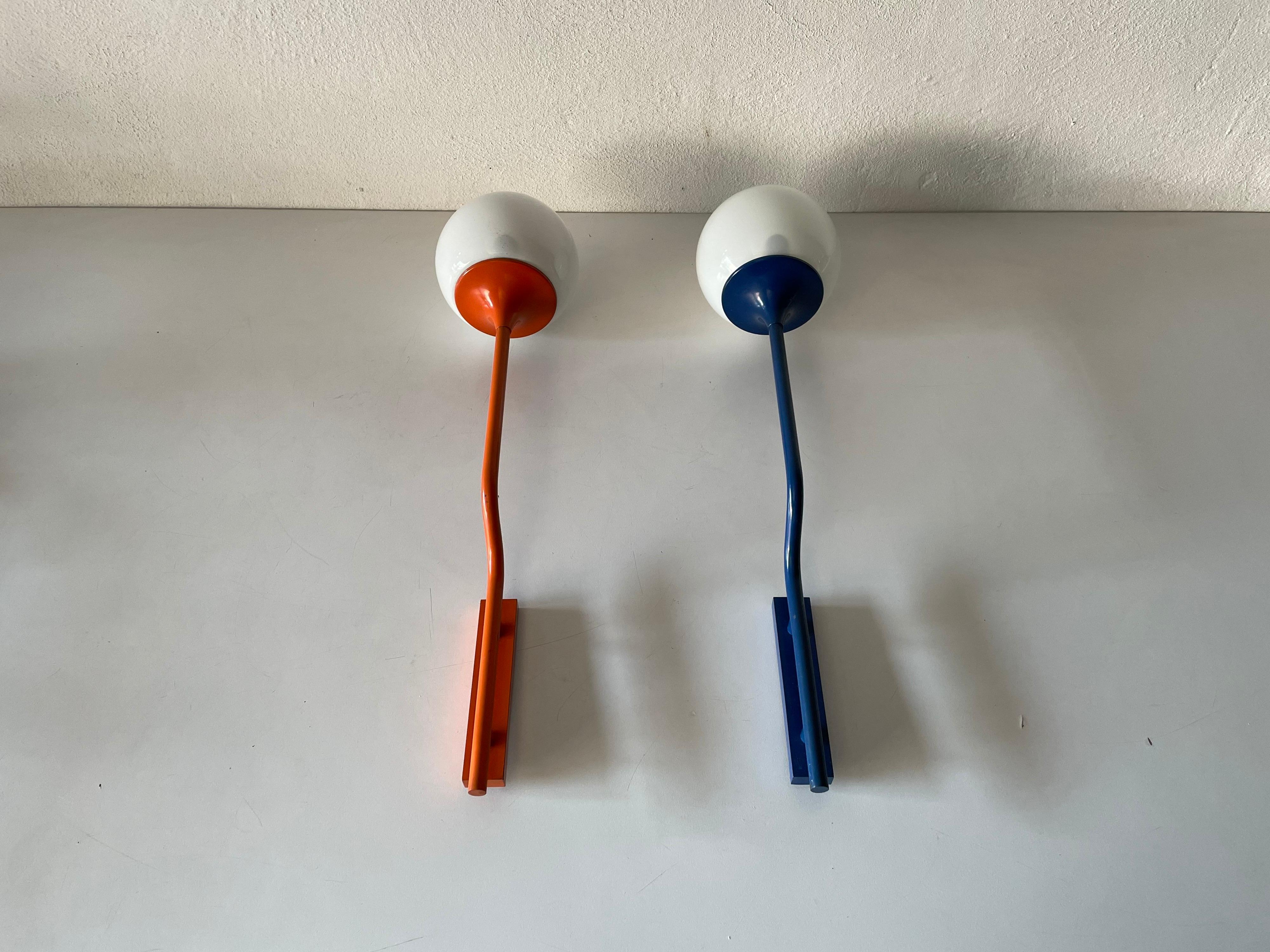 Very rare orange-Dark blue long metal body and glass pair of sconces by Reggiani, 1970s, Italy

Minimalist high quality design

Lamps are in very good vintage condition.
Wear consistent with age and use

These lamps works with E14 standard