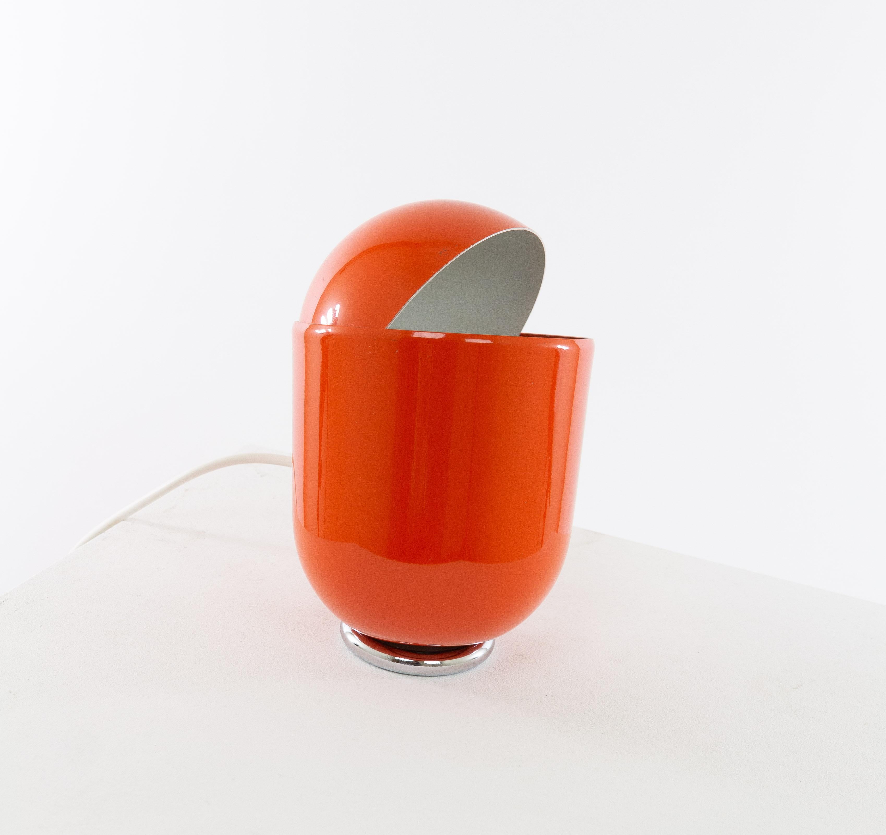 Orange adjustable table lamp, Elmo, designed and produced by Imago DP Milano in 1971.

This relatively small table lamp has a movable shade with which the light intensity can be adjusted. The round base is weighted which allows the lamp to be