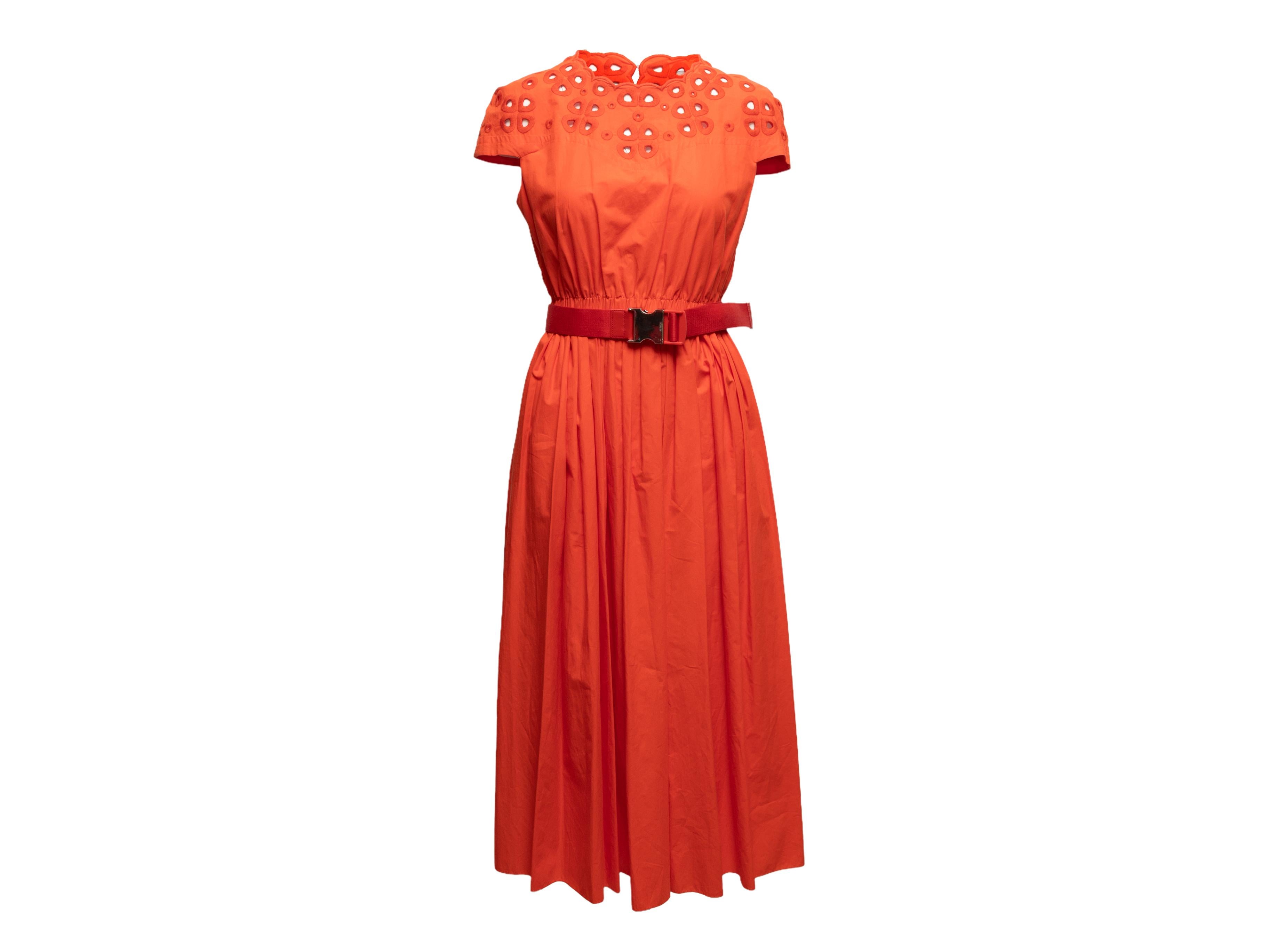  Orange short sleeve dress by Fendi. Eyelet detailing at crew neckline and shoulders. Elasticized waist featuring optional belt. Zip closure at center back. 34