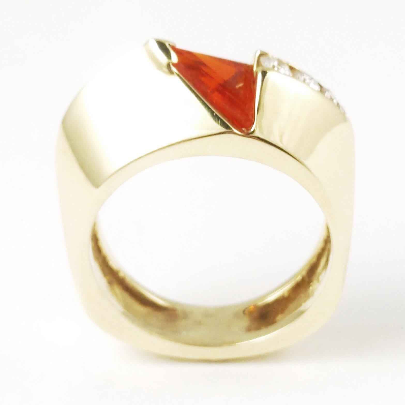 This Cornelis Hollander ring is featuring our favorite shape - the triangle. It features strait edge trillion cut fire opal channel set on an upward angle. The diamond weight is .11 ct. G VS2 quality. The finger size is currently a 5.5 but can be
