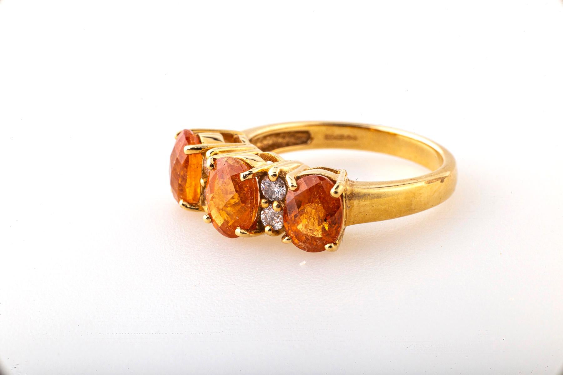 A treasure of nature the orange garnet is known as spessartine or spessartine. The stone is a soft orange here faceted paired with old mine and transitional diamonds that sparkle.. The gems generally have crystal or bubble like inclusions within