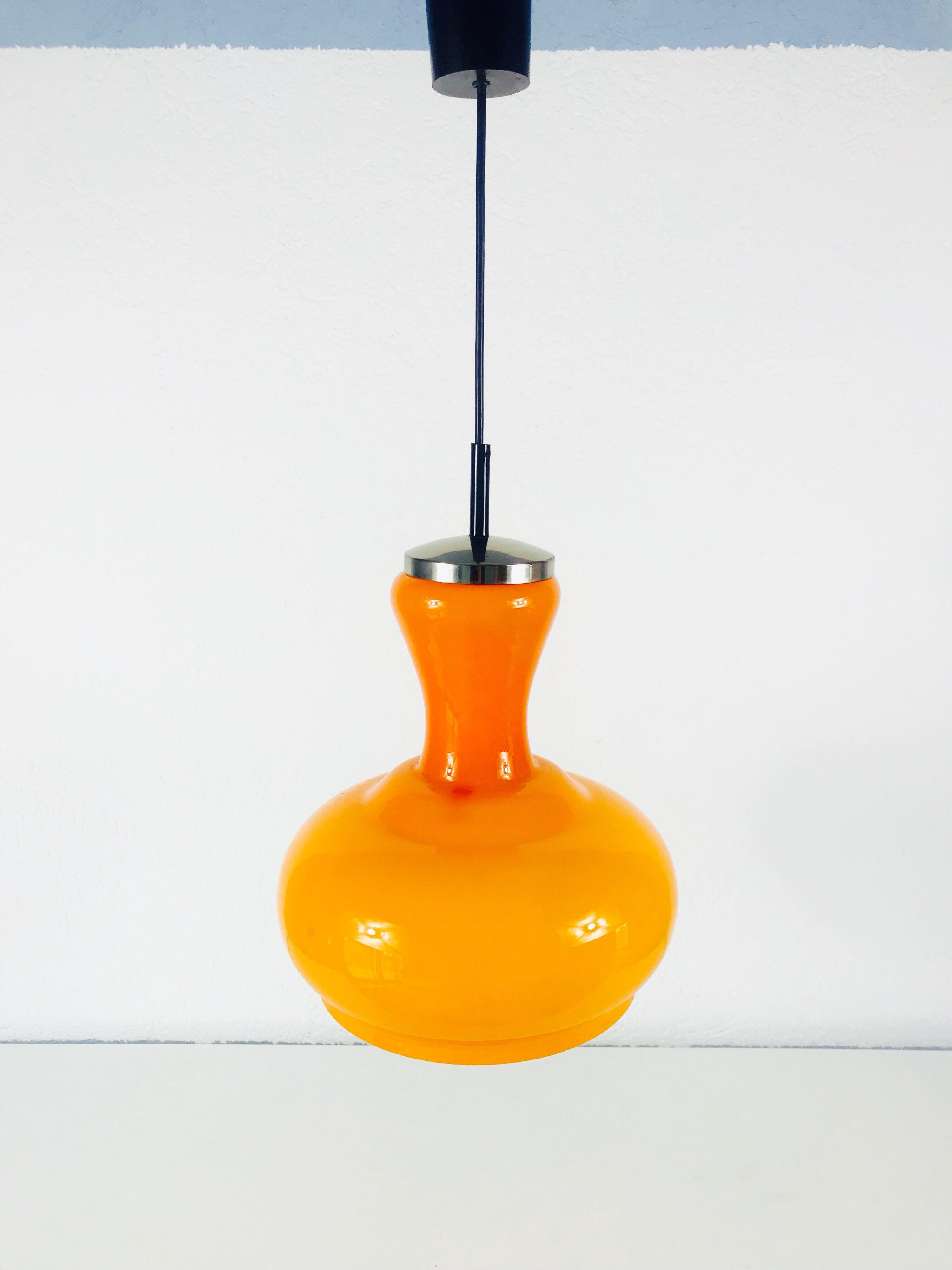 Orange glass hanging lamp from Peill & Putzler made in Germany in the 1970s. It has a Space Age design.

Measurements:

Height 57 cm

Diameter 26 cm

The light requires one E27 light bulb.