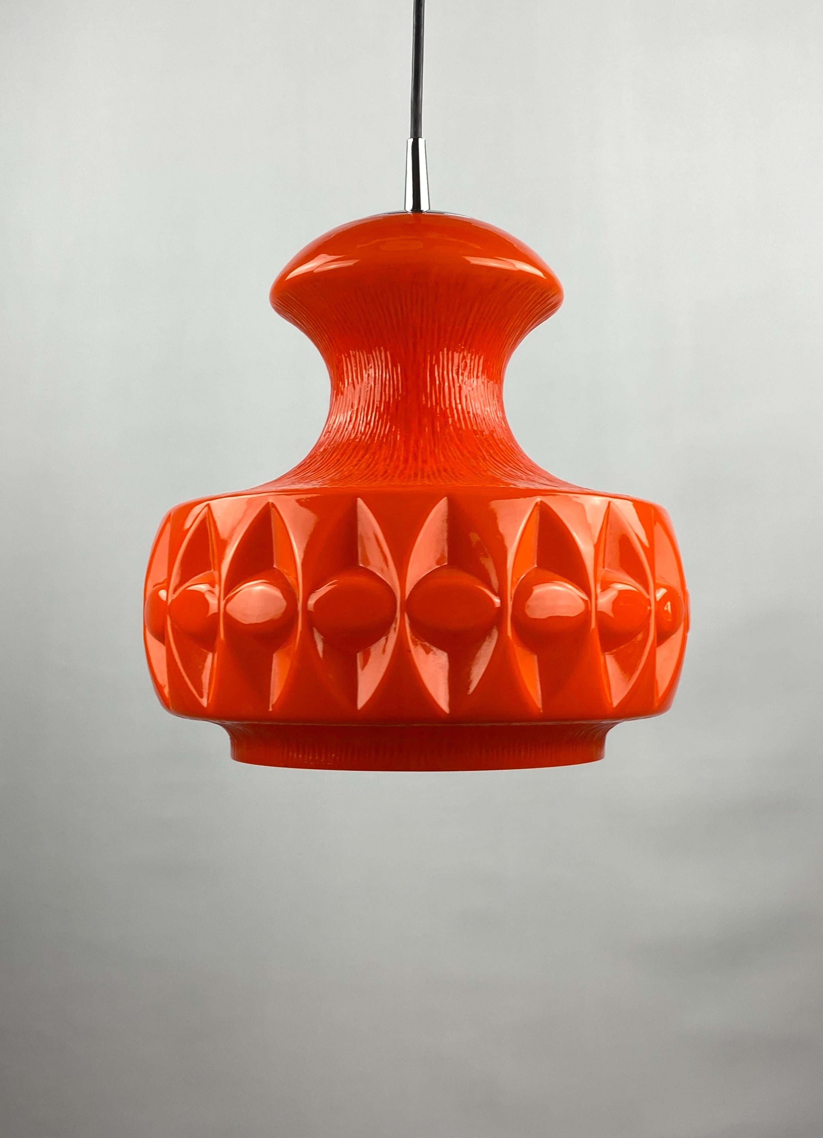 Uncommonly shaped orange glass pendant light by Peill and Putzler, produced around 1960 in Germany. Has a nice bright orange color and gives a very warm light.

Typical design of the German makers, also resembles the Swedish designs. More colored