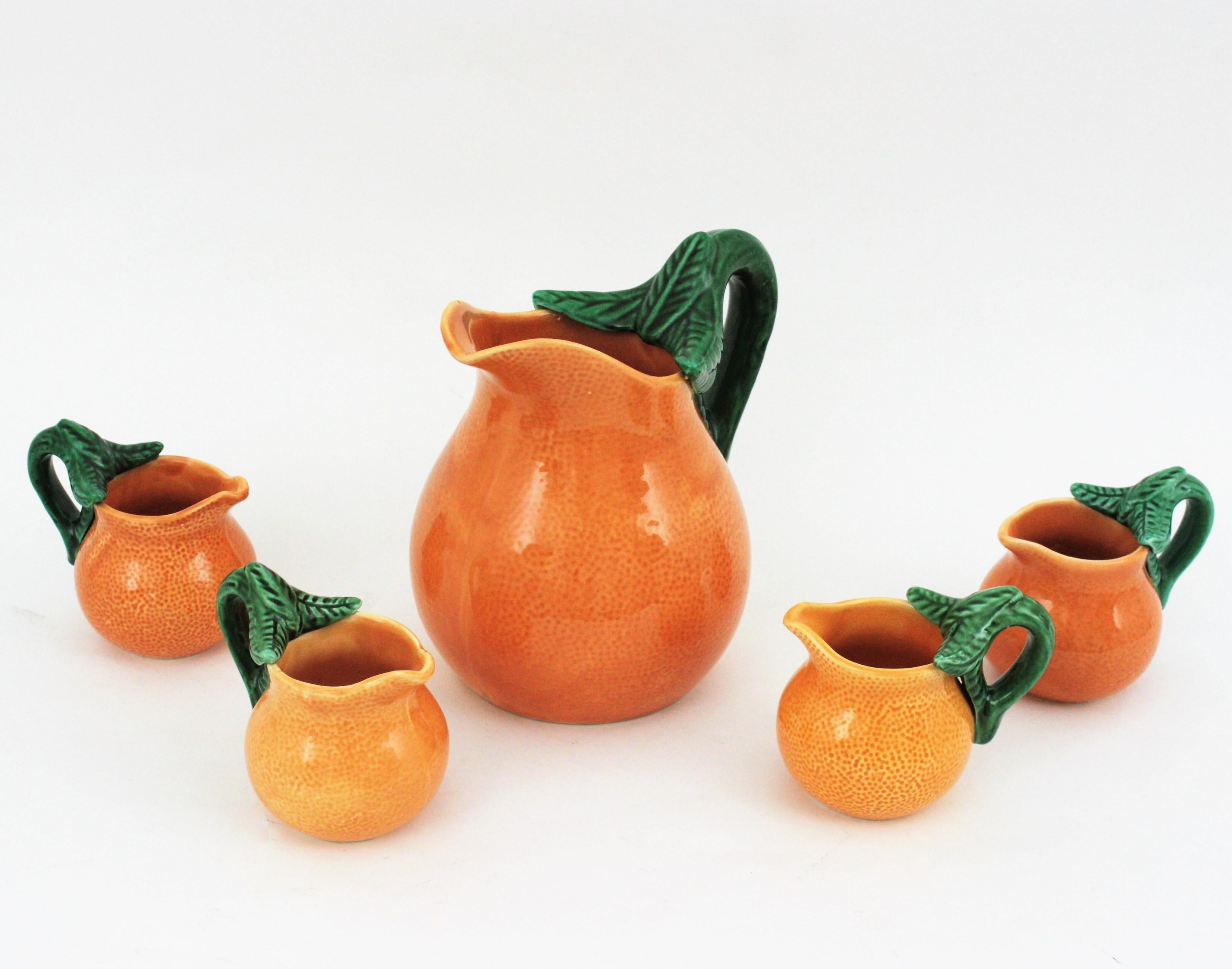 Coffee or tea sea set orange design, Spain, 1960s.
Cool set of hand-painted glazed ceramic orange shaped tea, coffee or breakfast serving set for four. The set is comprised by a large ceramic jug with orange shape and four ceramic cups same