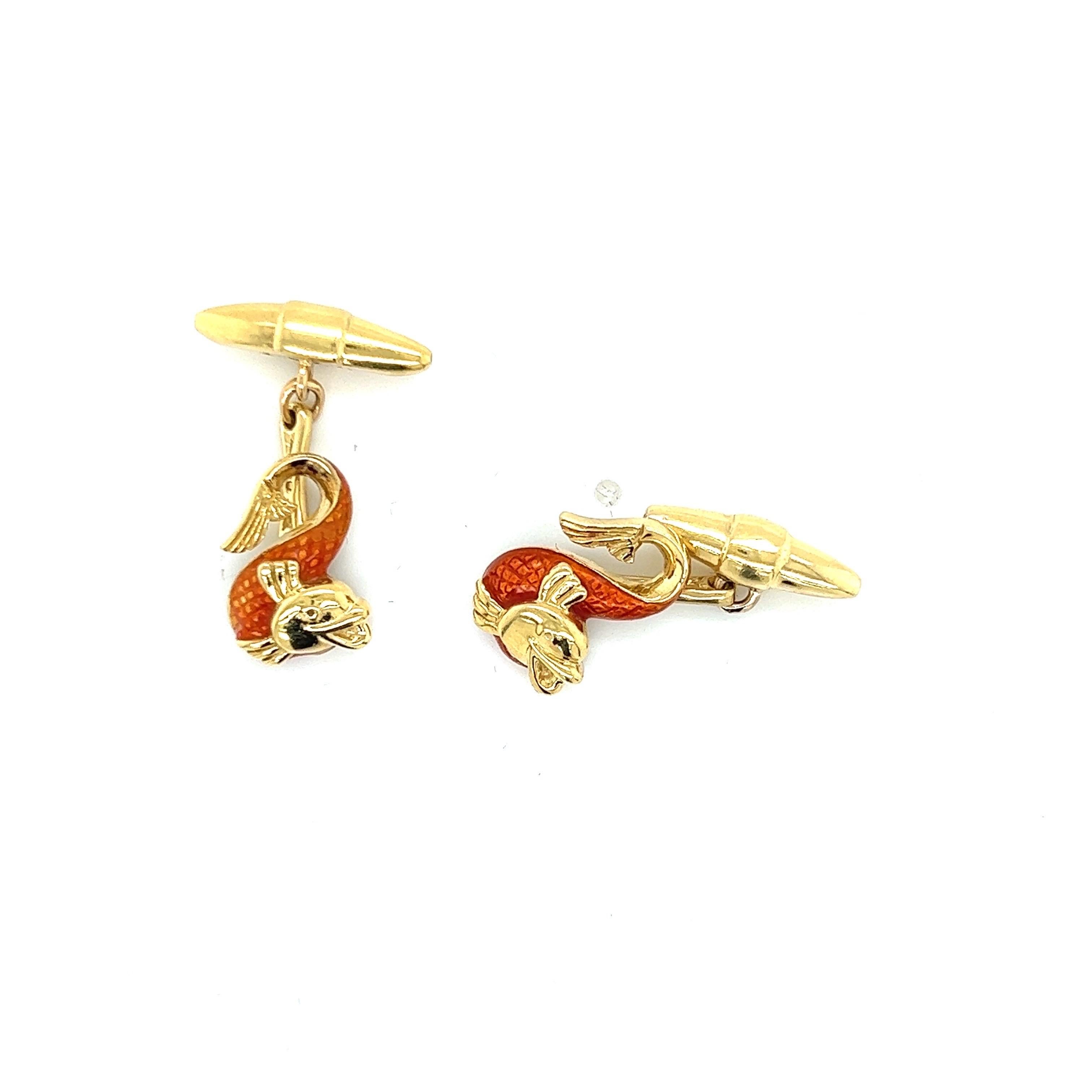Orange Guilloche Enamel Fish Cufflinks in 18k Yellow Gold are a charming and whimsical accessory that add a pop of color and personality to any formal or semi-formal attire. The cufflinks feature a playful fish motif, with intricately detailed