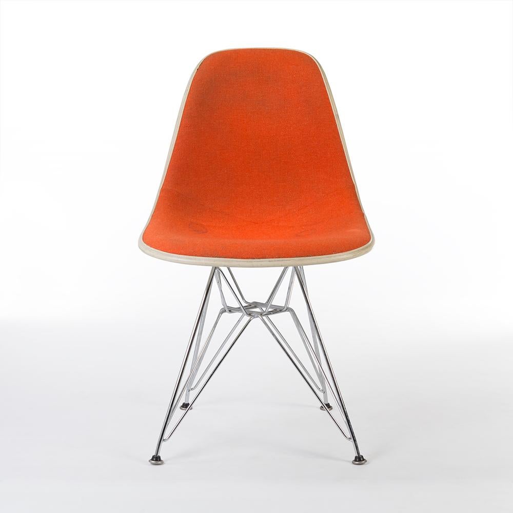 Vibrant and comfortable, this upholstered orange Herman Miller Eames DSR chair comprises of contrasting white fiberglass shell, and a new, silver and iconic Eiffel base. As with many vintage chairs, there are signs of use and the fabric will need