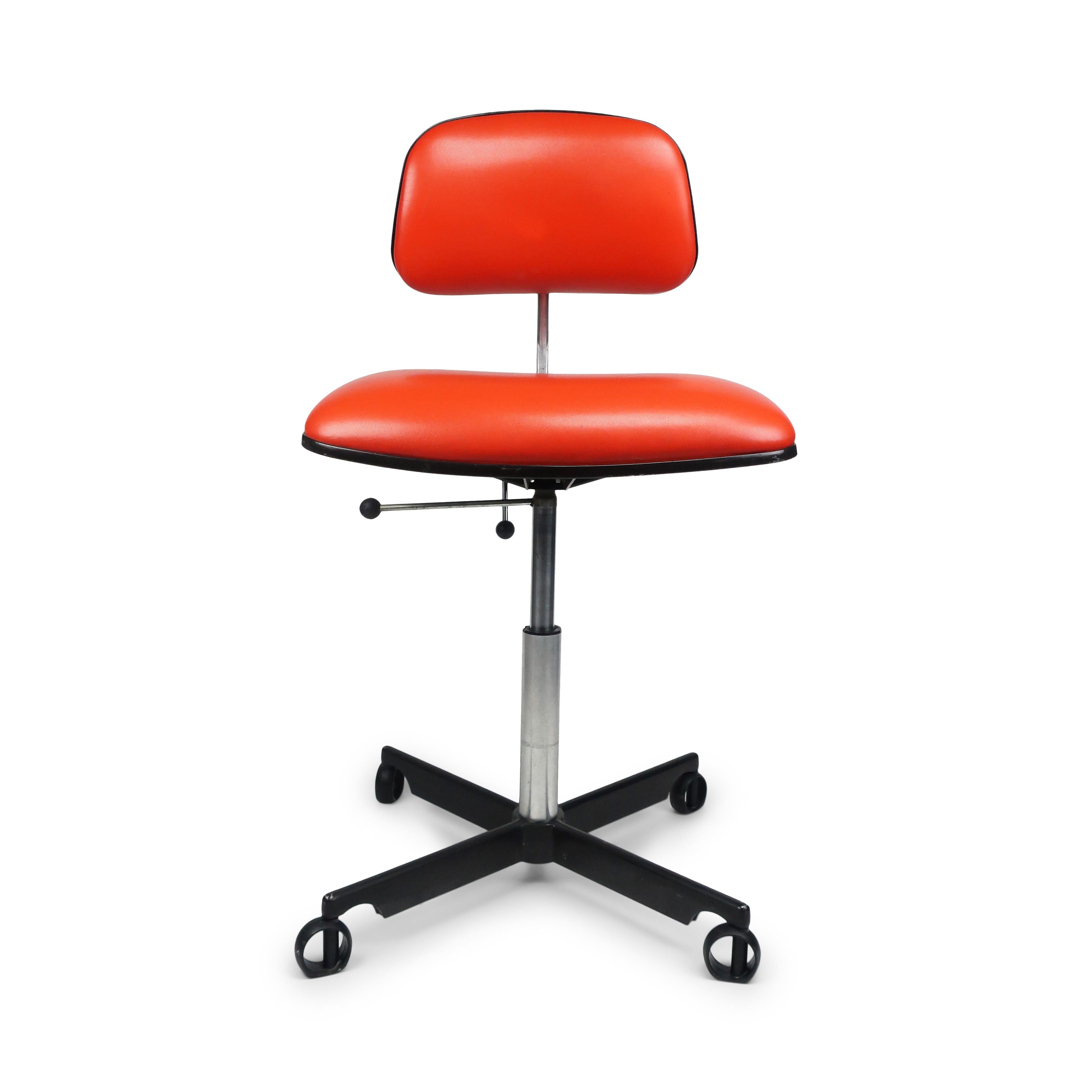 A great Kevi desk chair by Herman Miller with orange vinyl seat and back, black base, and polished aluminum stem. Includes seat height and back adjustment and rare non-rolling casters.

In very good vintage condition with wear consistent with age