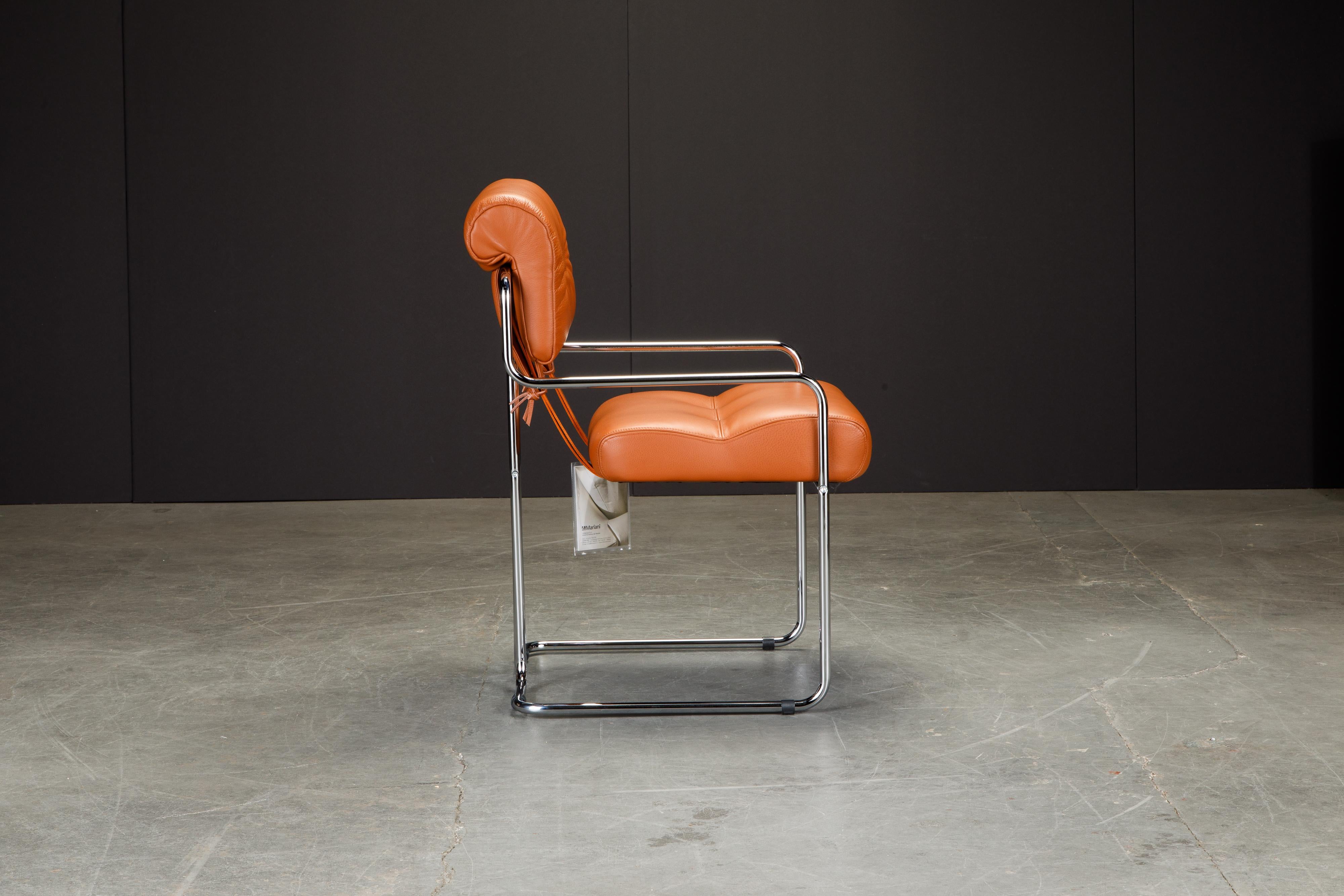 Currently, the most coveted dining chairs by interior designers are 'Tucroma' chairs by Guido Faleschini for i4 Mariani, and we have this brand new pair in beautiful orange leather with polished chrome frames. The seats and backs have supple orange