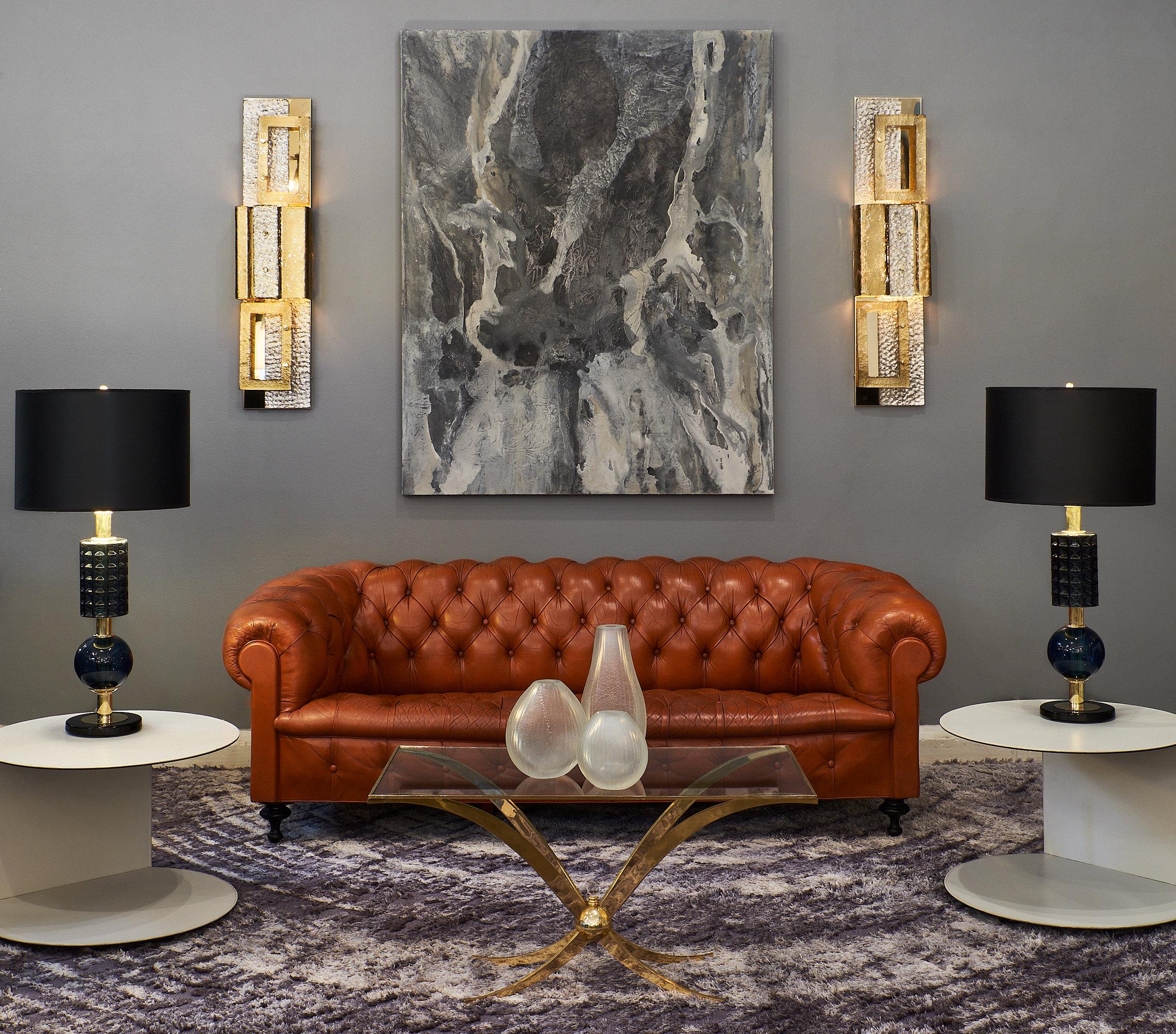 Vintage orange leather Chesterfield sofa with tufting throughout the back and seat. The arms curve beautifully in the traditional Chesterfield style, and the piece is supported by carved legs. The sofa is very comfortable, and the leather has a