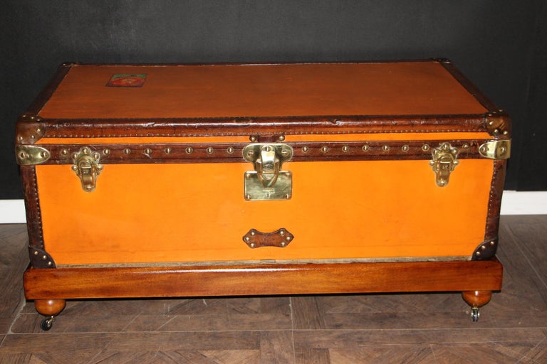 This very nice orange canvas Louis Vuitton steamer trunk, features Louis Vuitton stamped solid brass lock, clasps as well as all its studs. Beautiful and rich chocolate color leather trim and handles. Unusual and elegant proportions.
It is