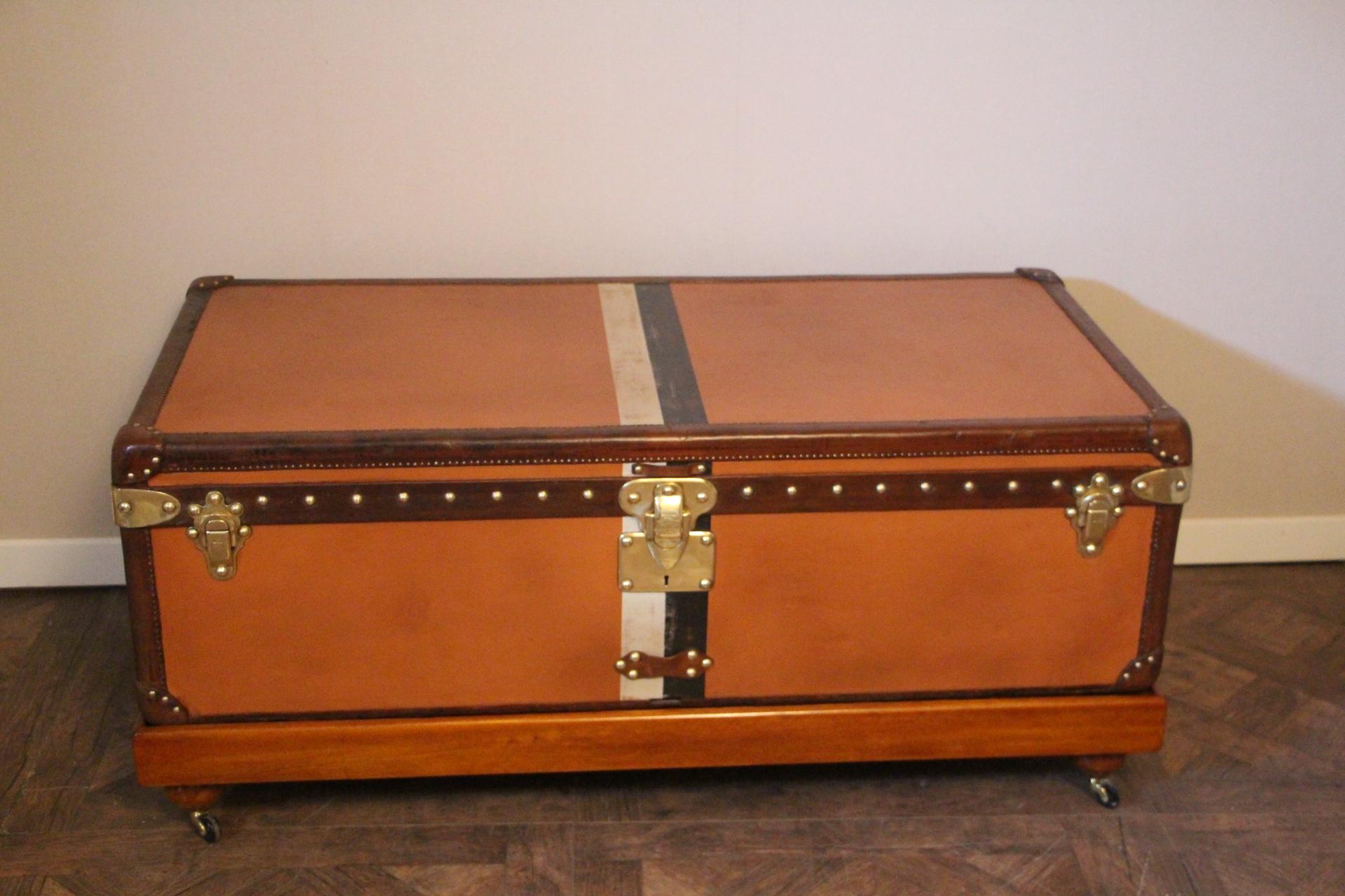 This very nice orange canvas Louis Vuitton steamer trunk, features Louis Vuitton stamped solid brass lock, clasps as well as all its studs. Beautiful and rich honey color leather trim and handles. Unusual and elegant proportions.
It is typically