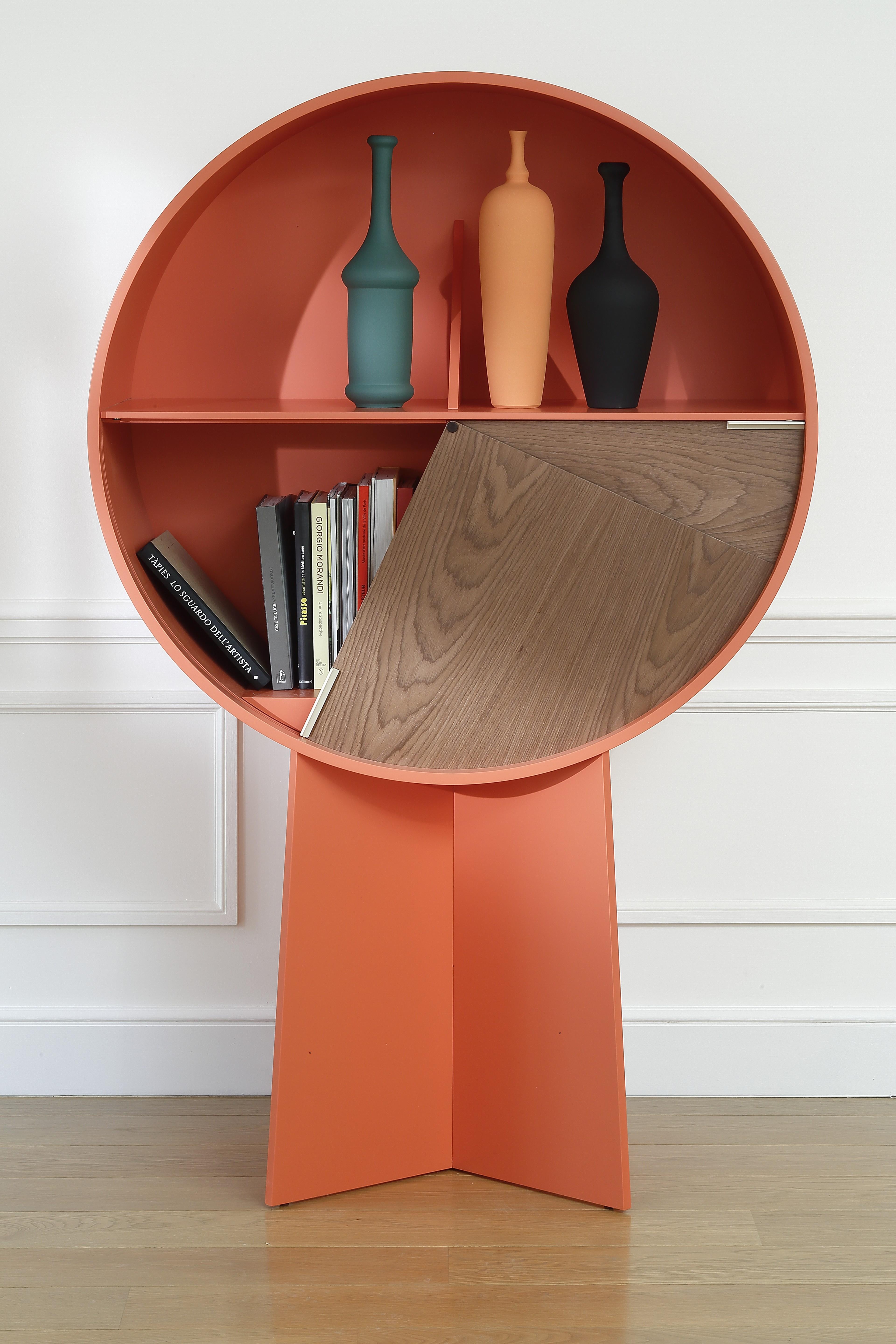 Orange luna storage cabinet by Patricia Urquiola
Materials: Walnut veneer on medium, or orange lacquer on medium. 2 sliding doors in two-tone lacquered hemispheres or in varnished walnut veneer
Technique: Lacquered or natural wood. 
Dimensions: D