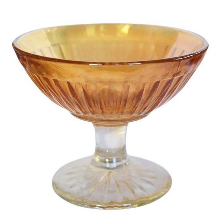 A set of five Mid-Century Modern orange carnival glass coupe champagne cups. This set of glasses will be a colorful addition to your barware. Each cup has a round, clear-footed base, with a floral etching at the bottom. The round body of each glass