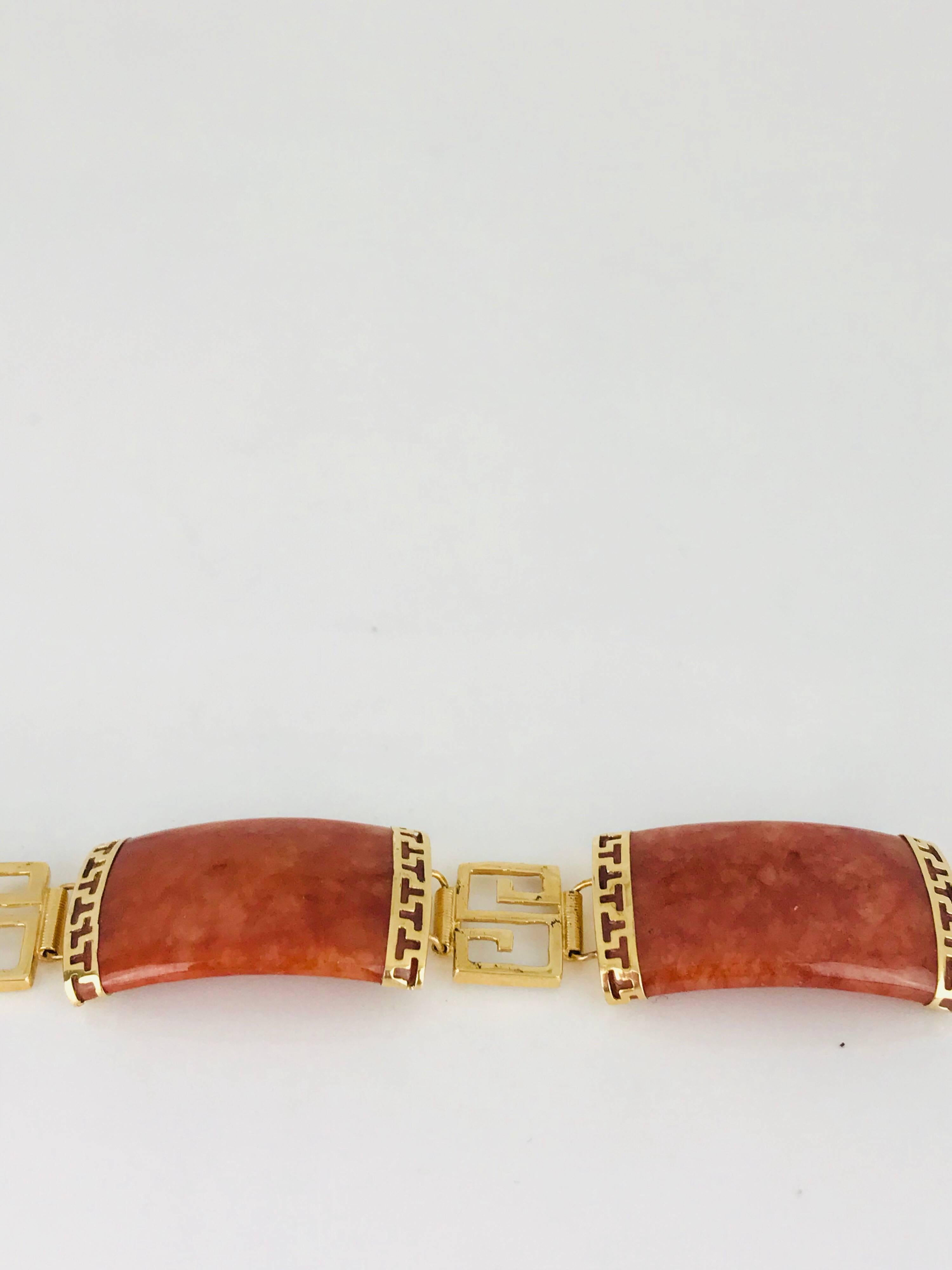 14 Karat yellow gold Jade bracelet. A stunning, 
Orange Marmalade color.
The length of the bracelet is 7-3/4 inches in length. 
This Retro bracelet is Circa 1965

GIA Gemologist Inspected & Evaluated $2000