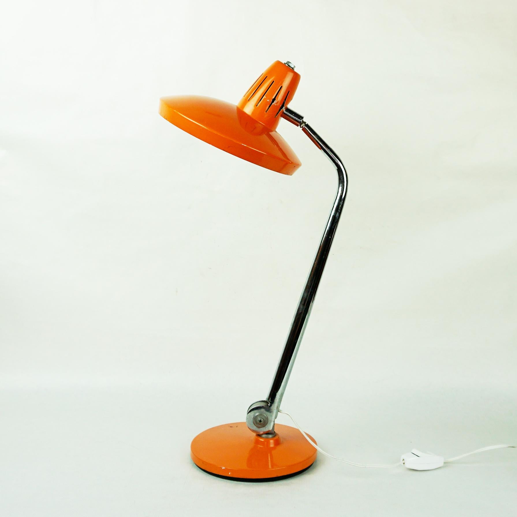 Iconic orange lacquered Desk Lamp produced by Fase Madrid Spain in the 1960s, the Model is called Fazo. It features a 360 swivelling base and 360 rotating shade. Marked Fase on the underside. 
So this light is adjustable in a lot of positions. All