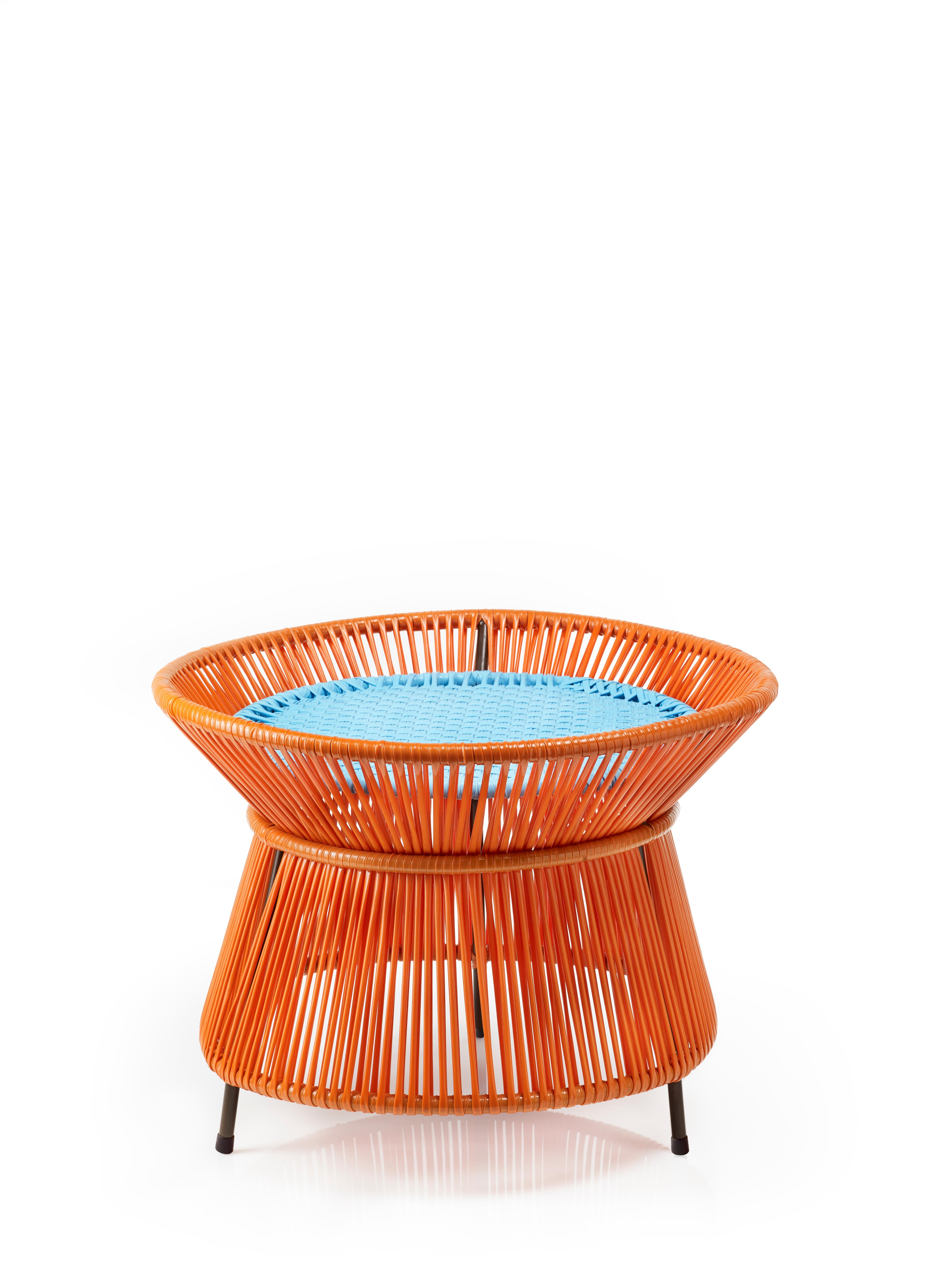 Orange Mint Caribe basket table by Sebastian Herkner
Materials: Galvanized and powder-coated tubular steel. PVC strings are made from recycled plastic.
Technique: Made from recycled plastic and weaved by local craftspeople in Colombia. 
Dimensions: