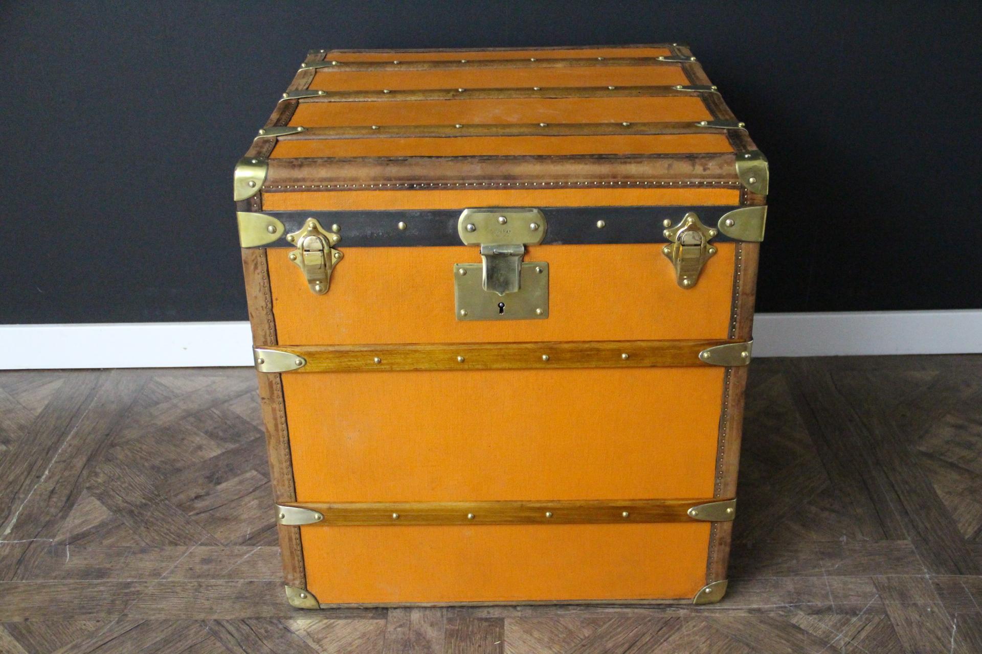 This beautiful and very rare Moynat trunk features beautiful orange canvas, chocolate color leather trim, large leather side handles with stamped Moynat flanges and solid brass stamped Moynat lock. Its patina is magnificent. Moreover it has a very