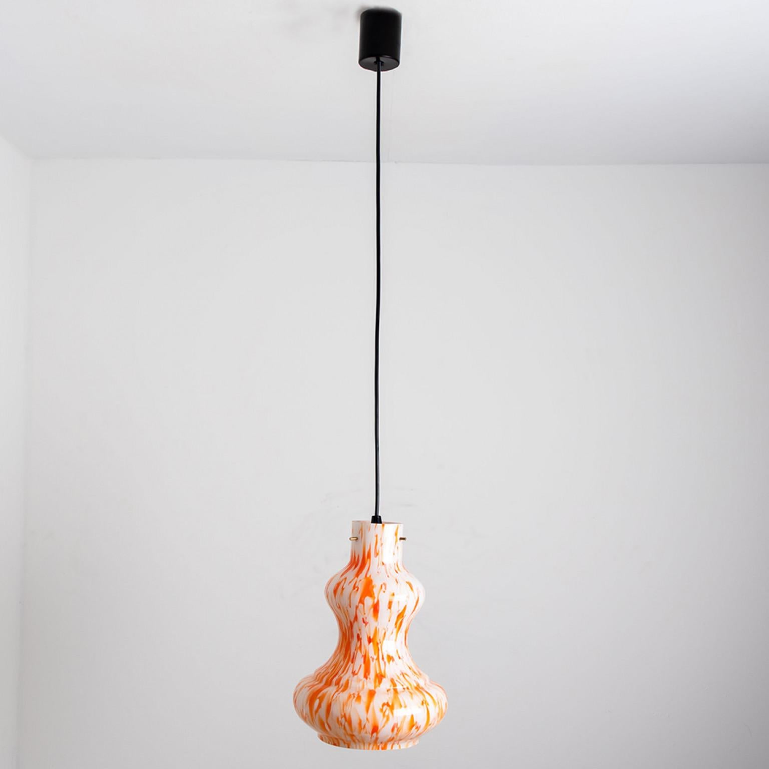A beautiful and unique orange and white glass pendant light, made in the 1960s by Massimo Vignelli for Venini.
The lampshade is made of orange and white opaline glass with an inner white glaze. Real murano glass, made in Italy.

We have two other