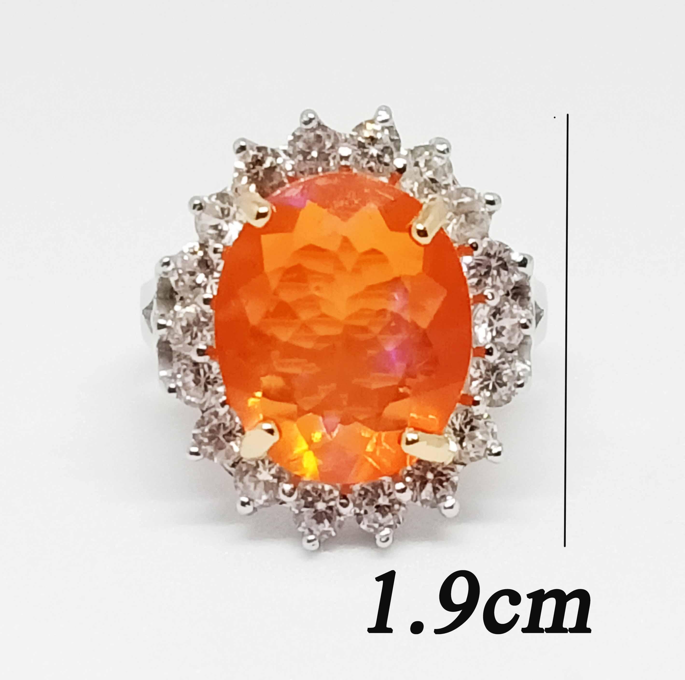 Orange Opal Oval size. 14x11.5 mm.(5.30cts)
White Zircon 2.0 mm 19 pcs.
18K White gold Plated over sterling silver.

Search Sellers, Storefront ( ornamento jewellery )