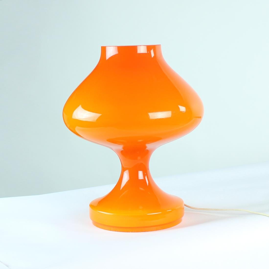 This is a beautiful table lamp with a statue like presence. Produced by OPP Jihlava in 1960s, designed by Stefan Tabery. The lamp is made out of one piece of orange opaline glass piece. No damage or chips on the glass, the lamp is in an excellent