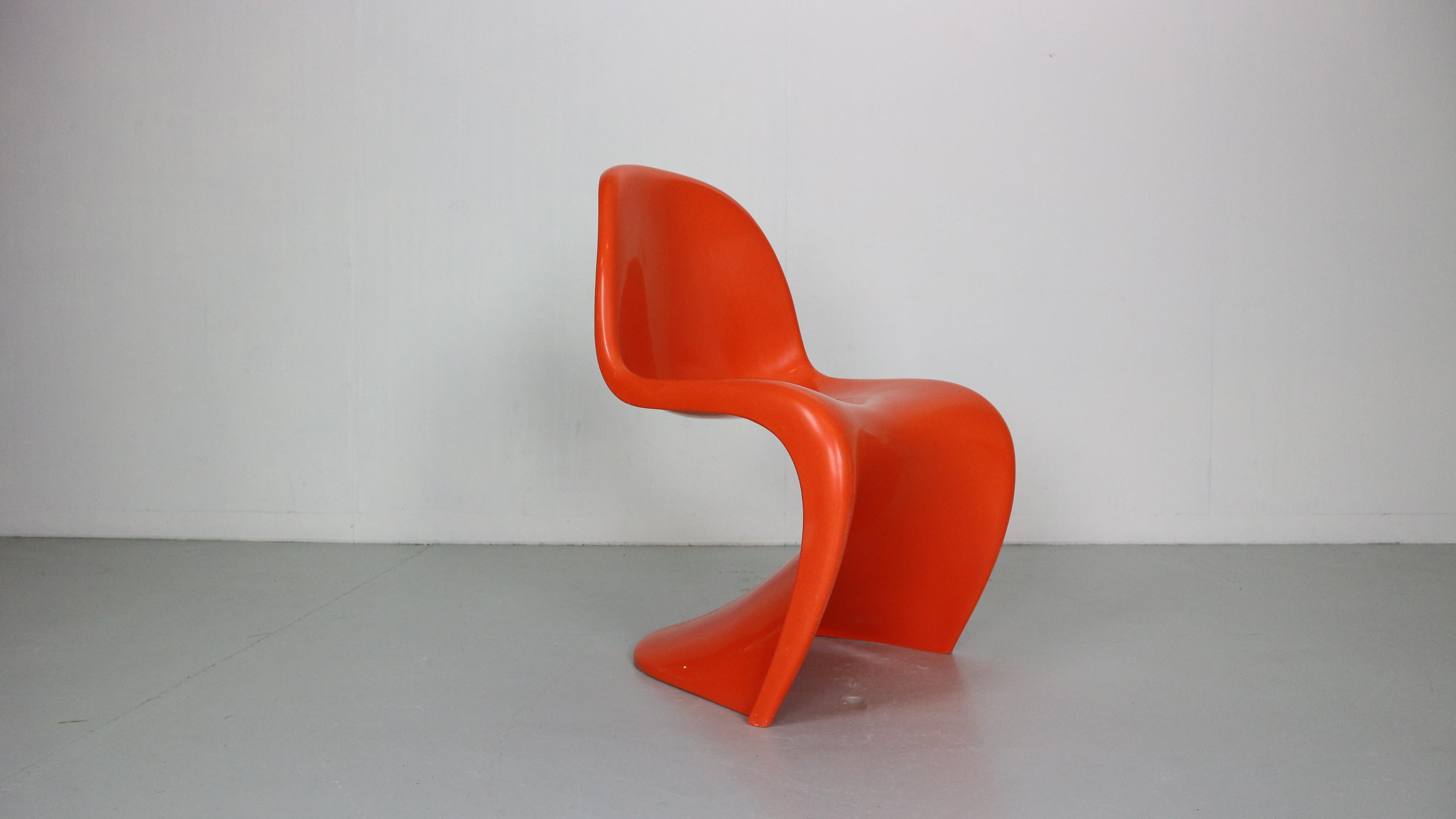 Original Panton chair was made by Herman Miller Fehlbaum in 1974. 
This well-known design, released in 1967, is the signature work of Verner Panton in its most original version.
Orange colour.
Originally marked.
Great condition due to it's age