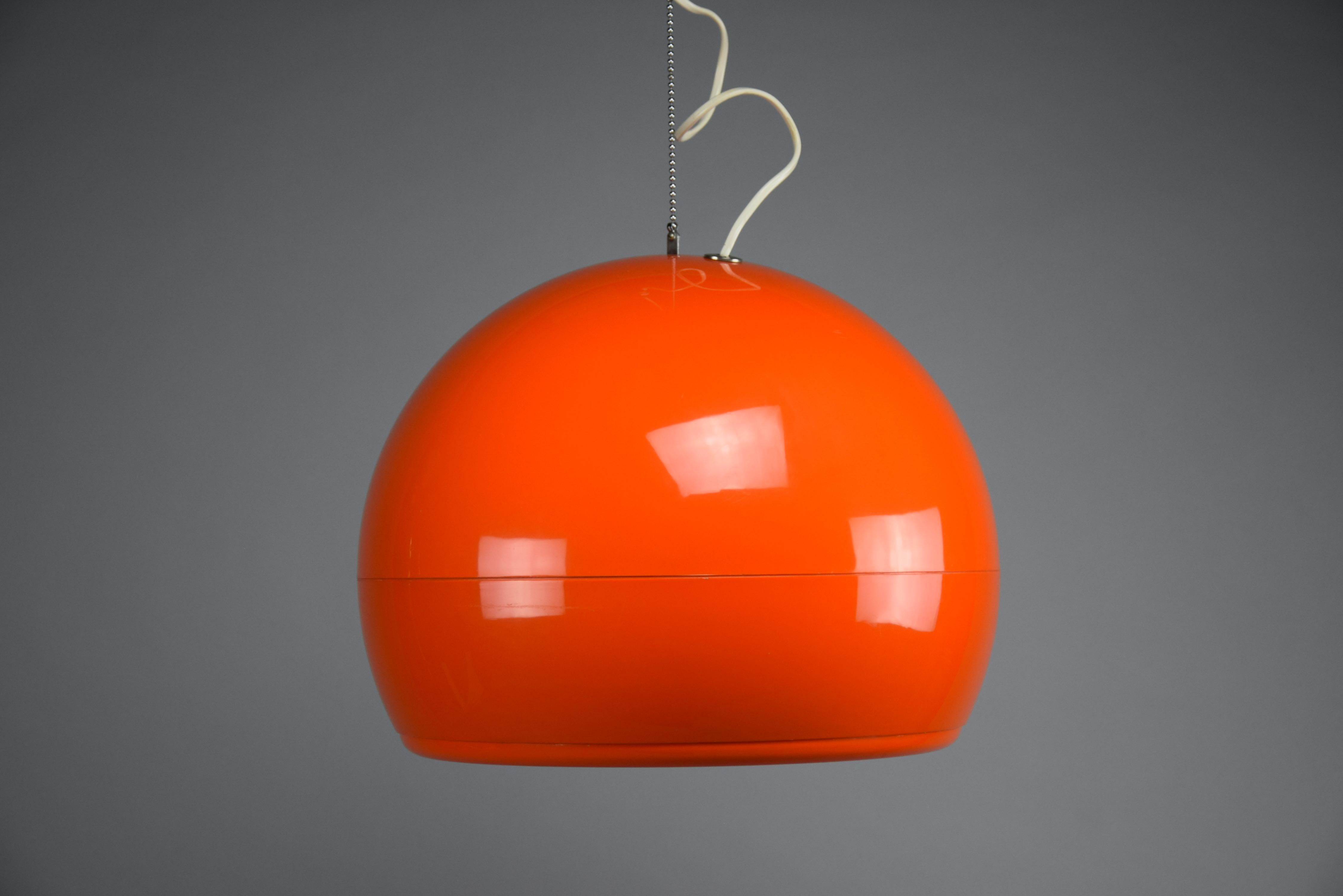 Illuminez votre espace avec une élégance intemporelle et un design emblématique grâce au superbe plafonnier orange Pallade, conçu en 1968 par le Studio Tetrarch pour Artemide. Cette pièce exquise incarne non seulement l'esprit du modernisme du