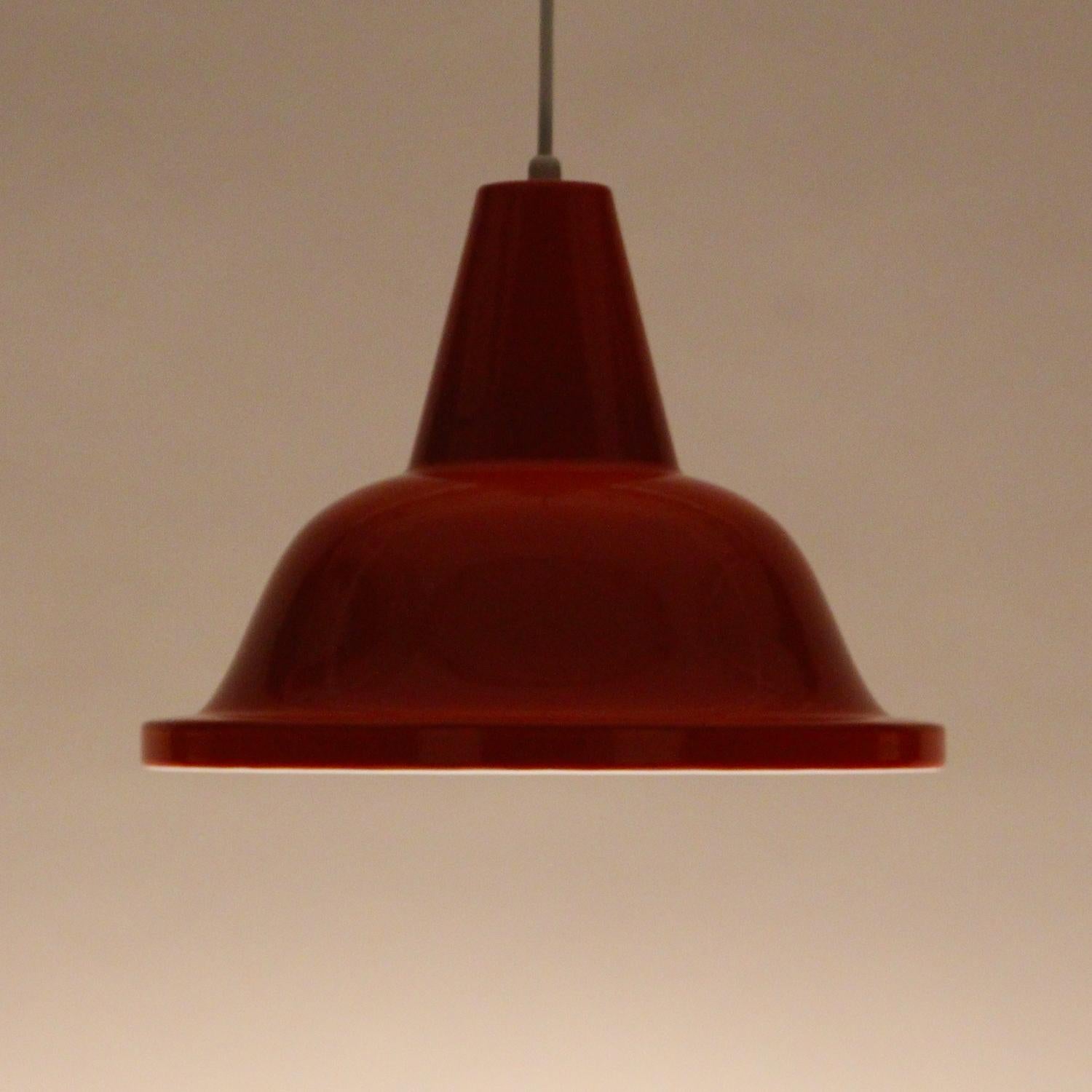 Orange pendant, circa 1960s Scandinavian industrial hanging lamp in bright orange enamel - in excellent vintage condition.

A large metal pendant, coated with shiny bright orange enamel on the outside, while the inside is coated with shiny white