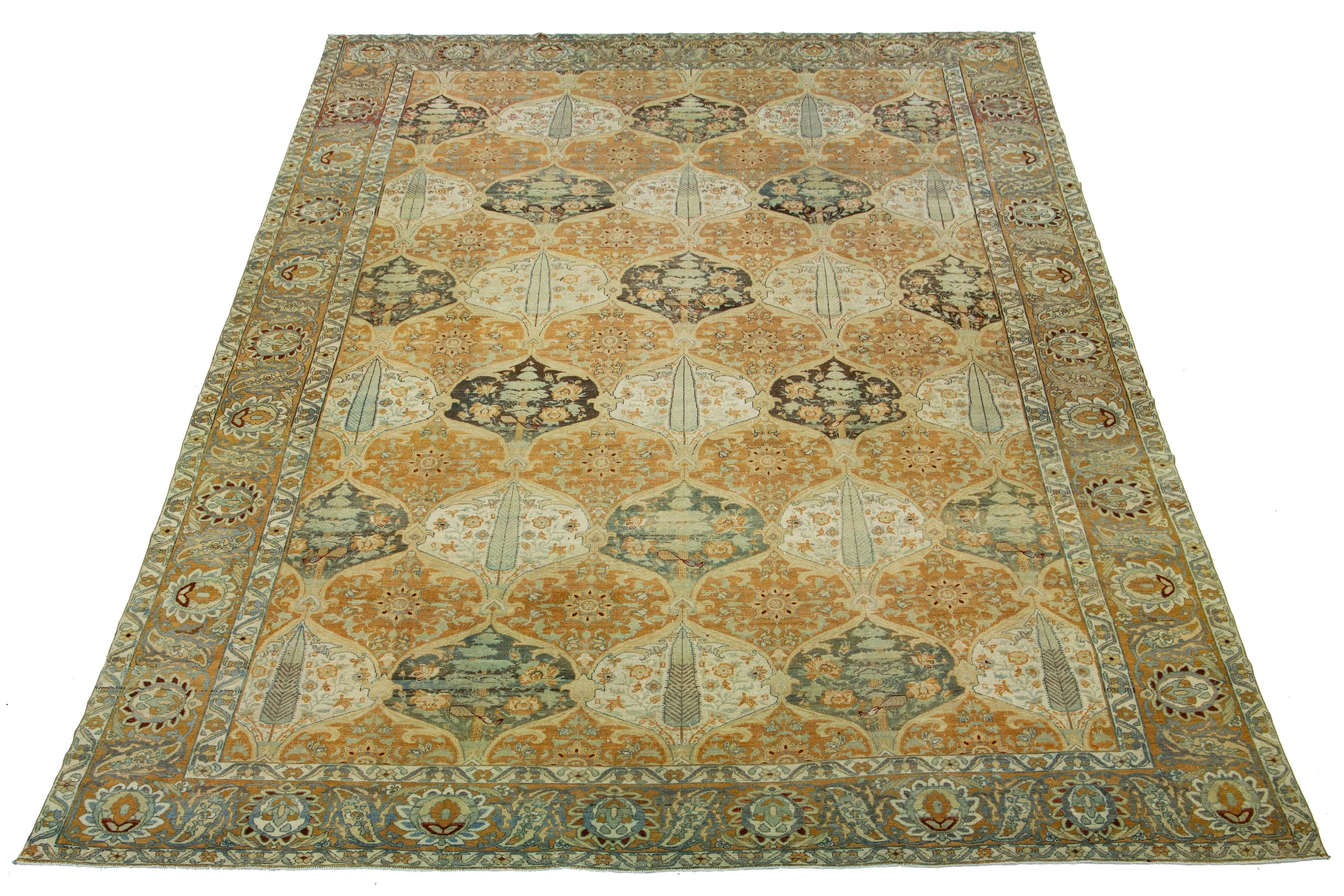 Beautiful Antique Bakhtiari hand-knotted wool rug featuring an orange-colored field. This exquisite Persian rug showcases a classic geometric floral design with blue, beige, red-rust, and gray hues.

This rug measures 13'3