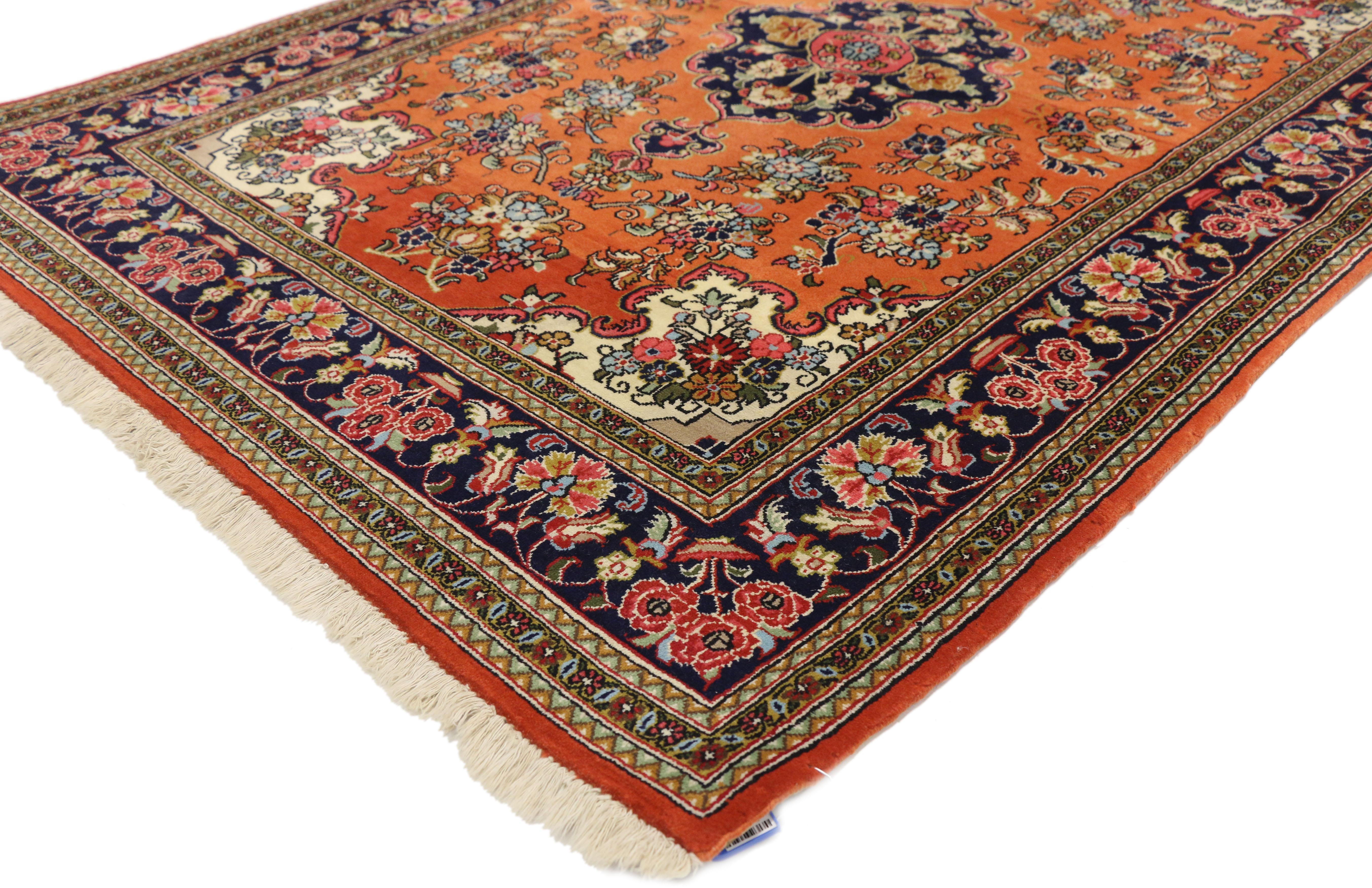 74689, Orange Vintage Persian Qum Floral Silk Rug with French Rococo Style. The Persian Qum silk rug with French Rococo style features a central floral medallion on a field of abrash orange filled with floral bouquets in variegated shades of blue,