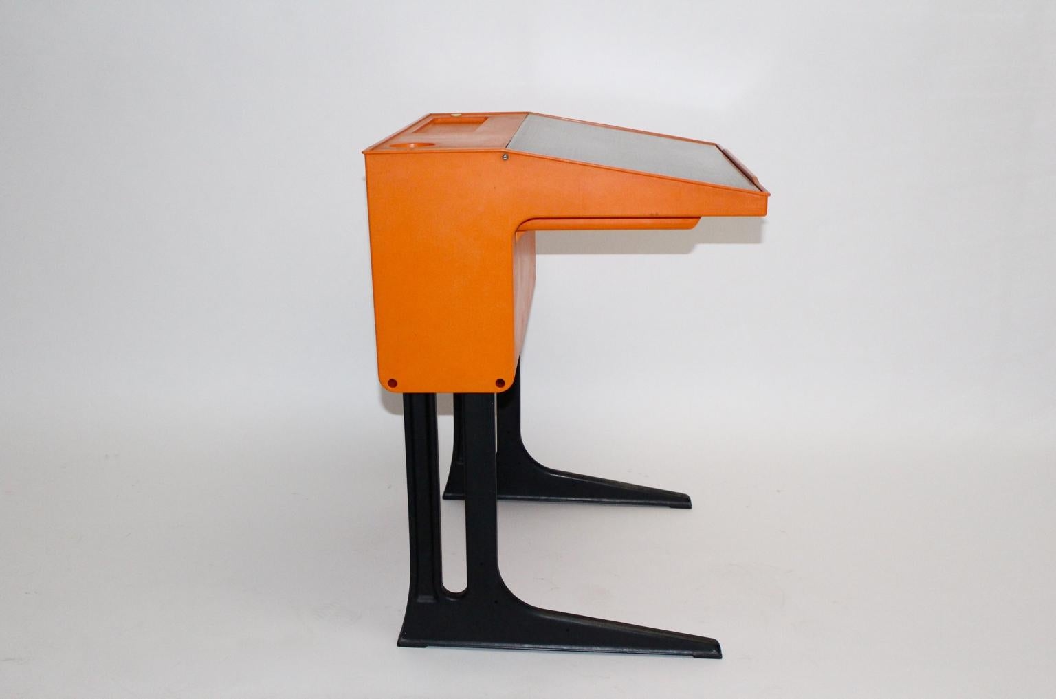 Space Age orange vintage desk designed by Luigi Colani for Flötotto, Germany, circa 1970.
While the body shows a bold orange color tone, the writing flap is brown.
Possible to use as a writing desk for children and for adults, the desk is adjustable