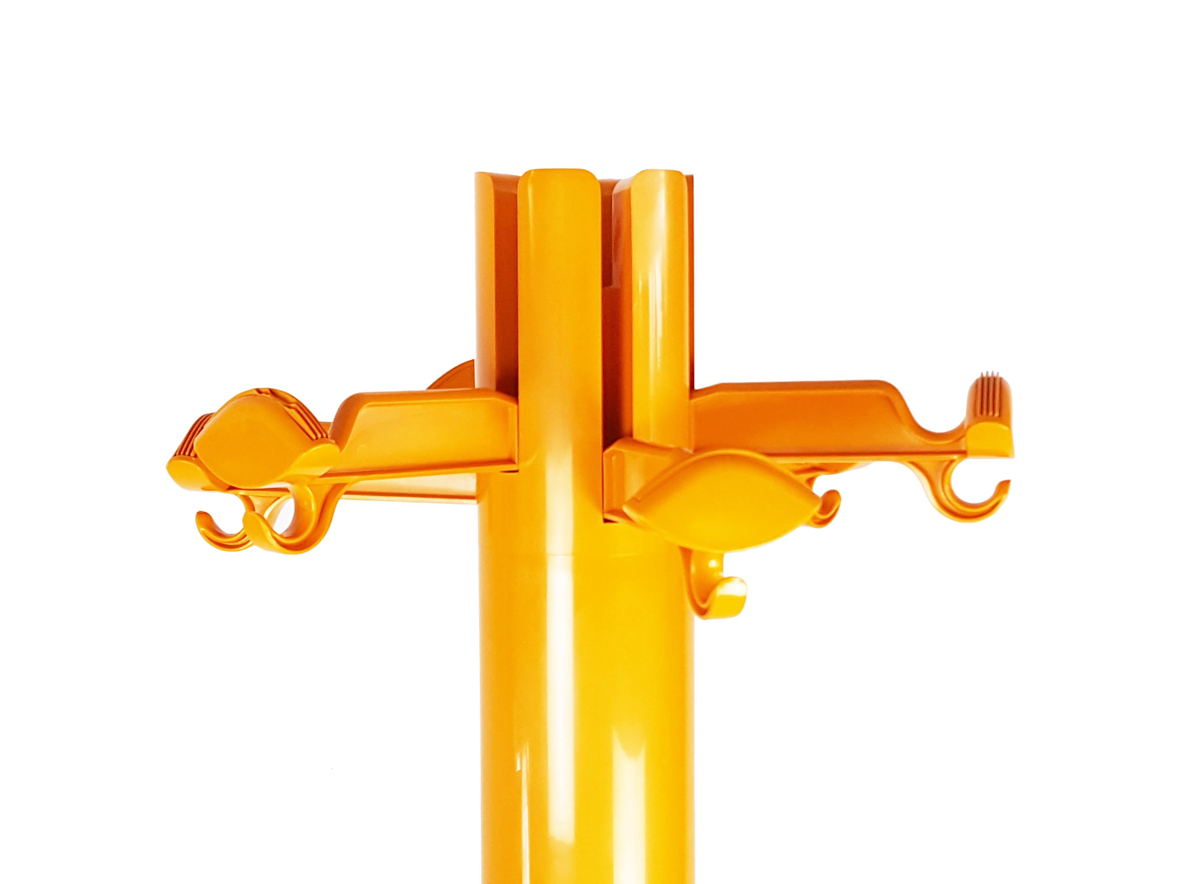 Orange plastic free standing coat rack with folding hooks & umbrella holders. Overall good condition: normal signs of wear and light scratches. One plastic breackage visible along the rod.