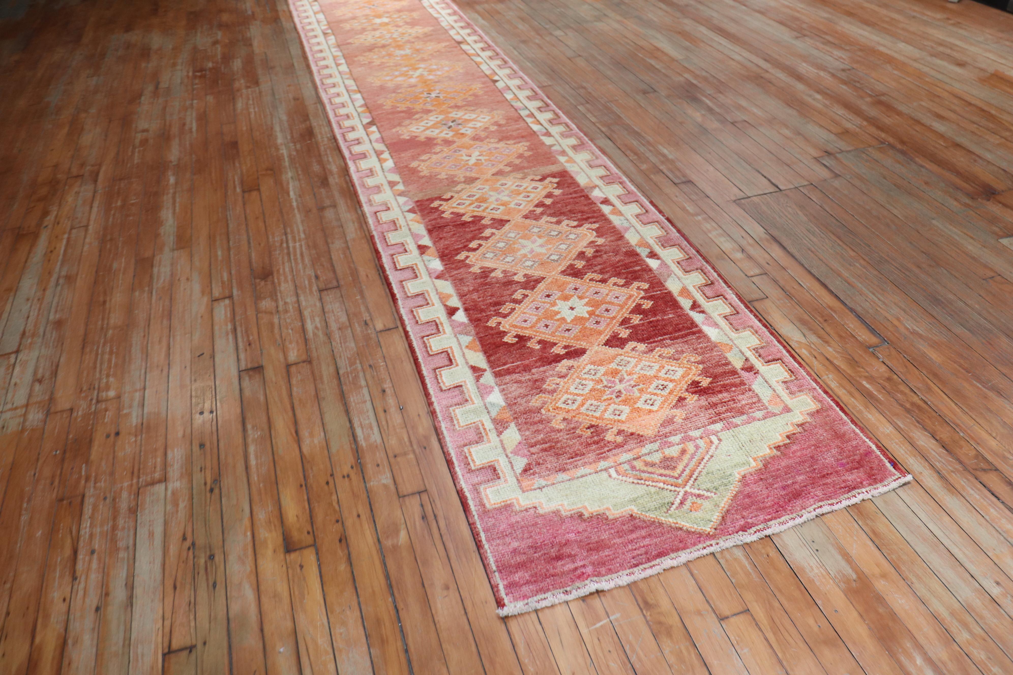 Long vintage Turkish Anatolian runner with a striated burnt red field multiple orange color medallions

Measures: 2'10