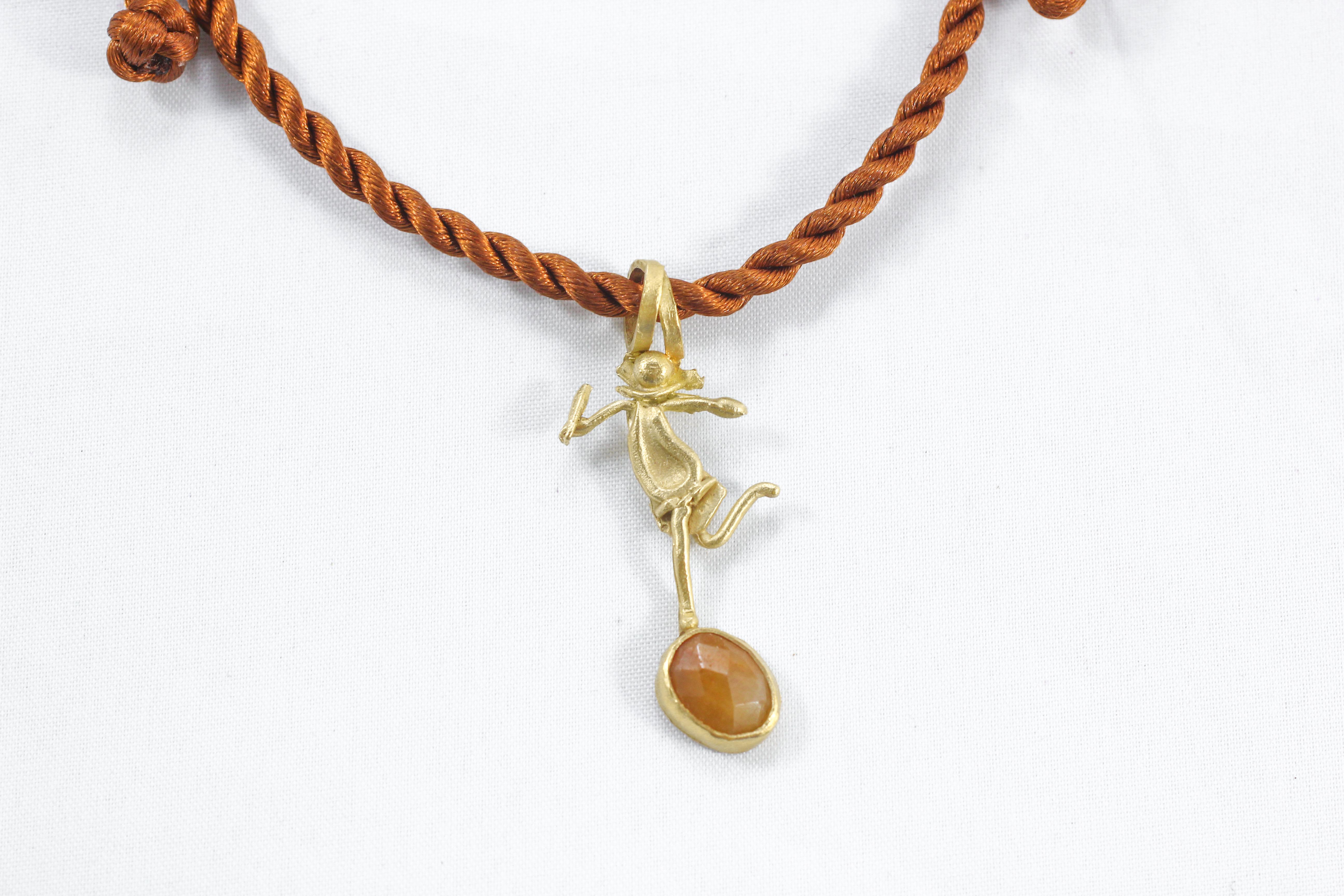 DANCE, She pendant drop necklace on silk cord/rope (included in the price). 18K gold dancing figure with a rose-cut sapphire set in a bezel. Also, pictured together with He pendant and on a leather multi-strand necklace (all sold separately).
