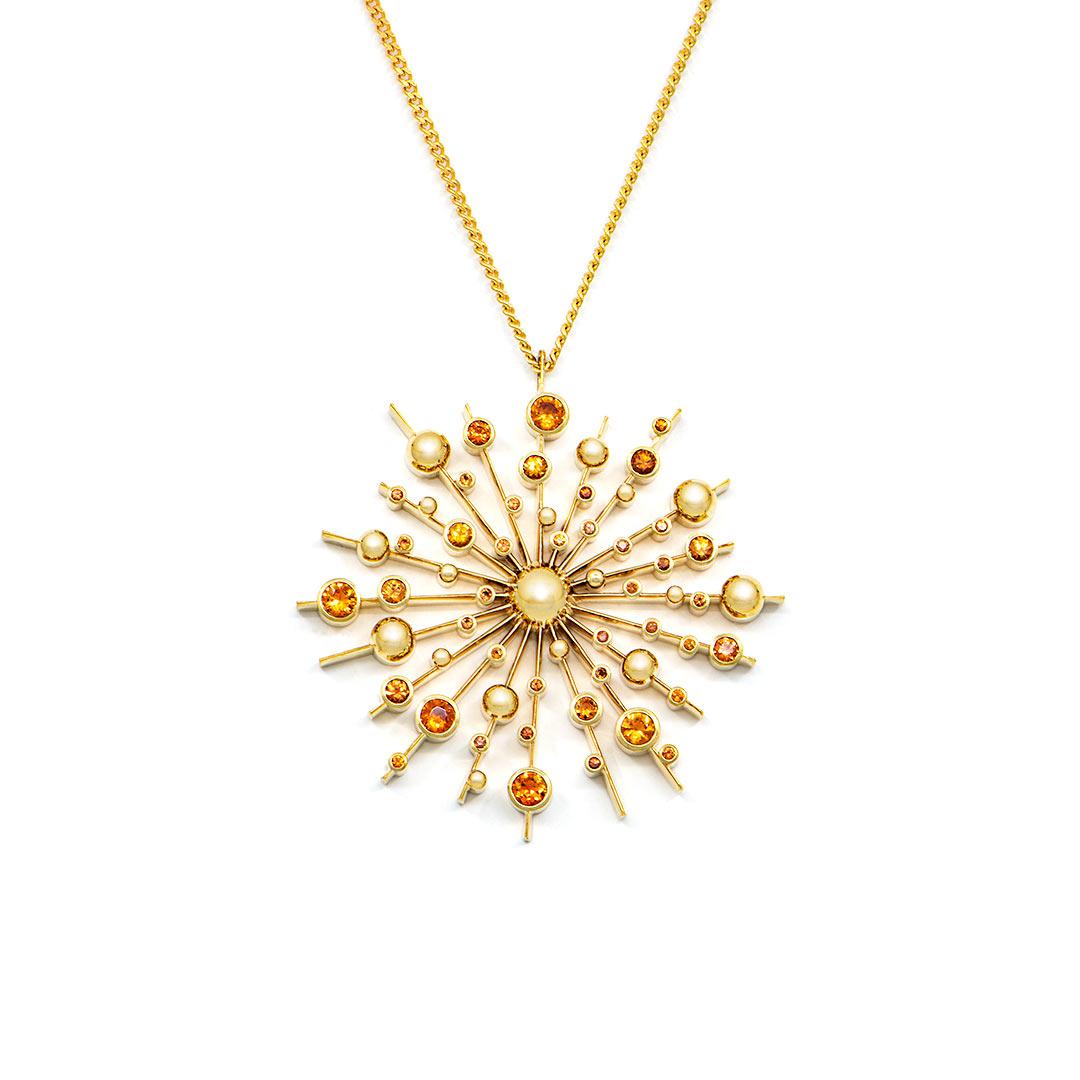 Part of the 'Soleil' collection by Natalie Barney, this pendant necklace features 40 Orange Sapphires with a total weight of 1.14 carats. This pendant comes complete with a 45cm fine trace chain.

Made in 9 carat yellow gold.  Please request the