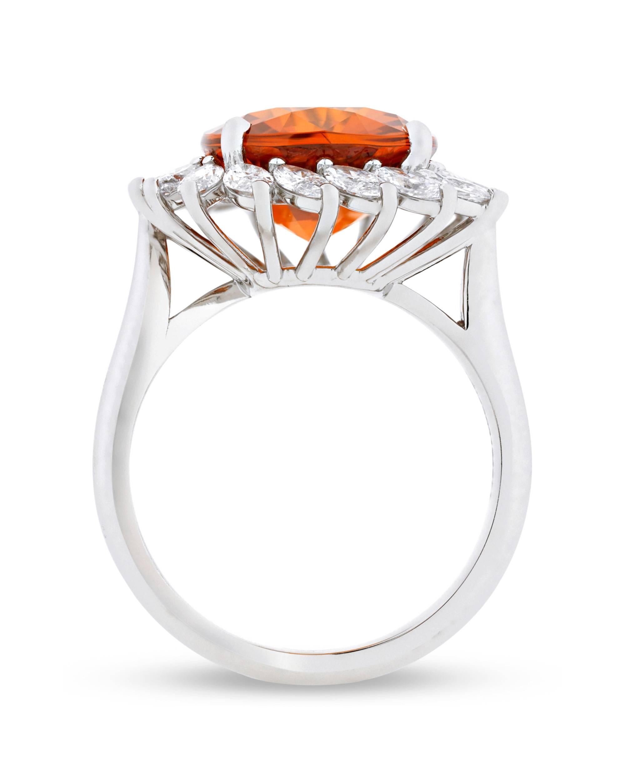 Encircled by a laurel wreath of exquisite marquise white diamonds is this captivating 8.08-carat orange sapphire. While sapphires are most commonly found in shades of yellow or blue, this jewel's rich orange is reminiscent of a mandarin garnet or