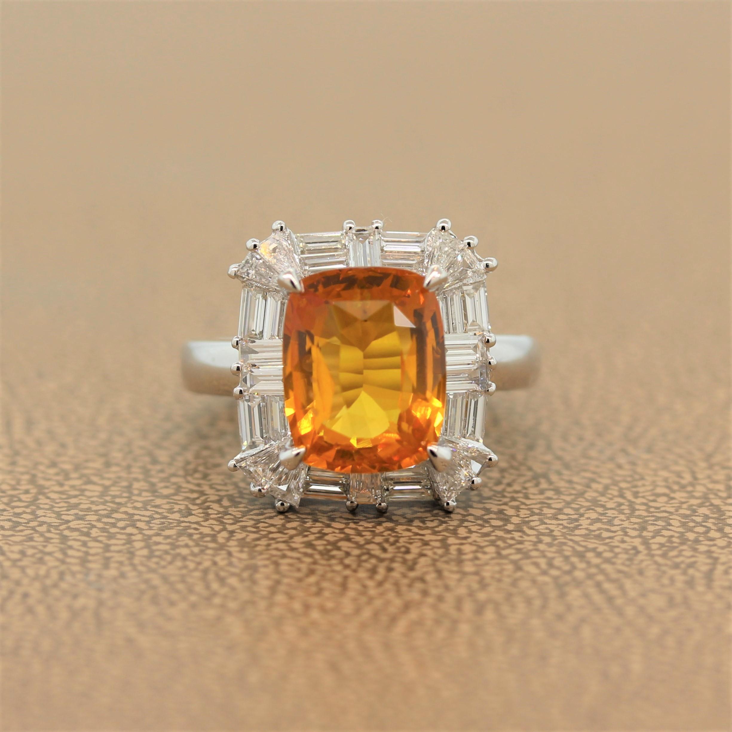 A lively ring featuring a 5.33 carat vivid orange sapphire. The cushion cut fancy colored sapphire is haloed by a decorative pattern of 1.69 carats of baguette and tapered baguette cut sparkling colorless diamonds in a hand fabricated 18k white gold