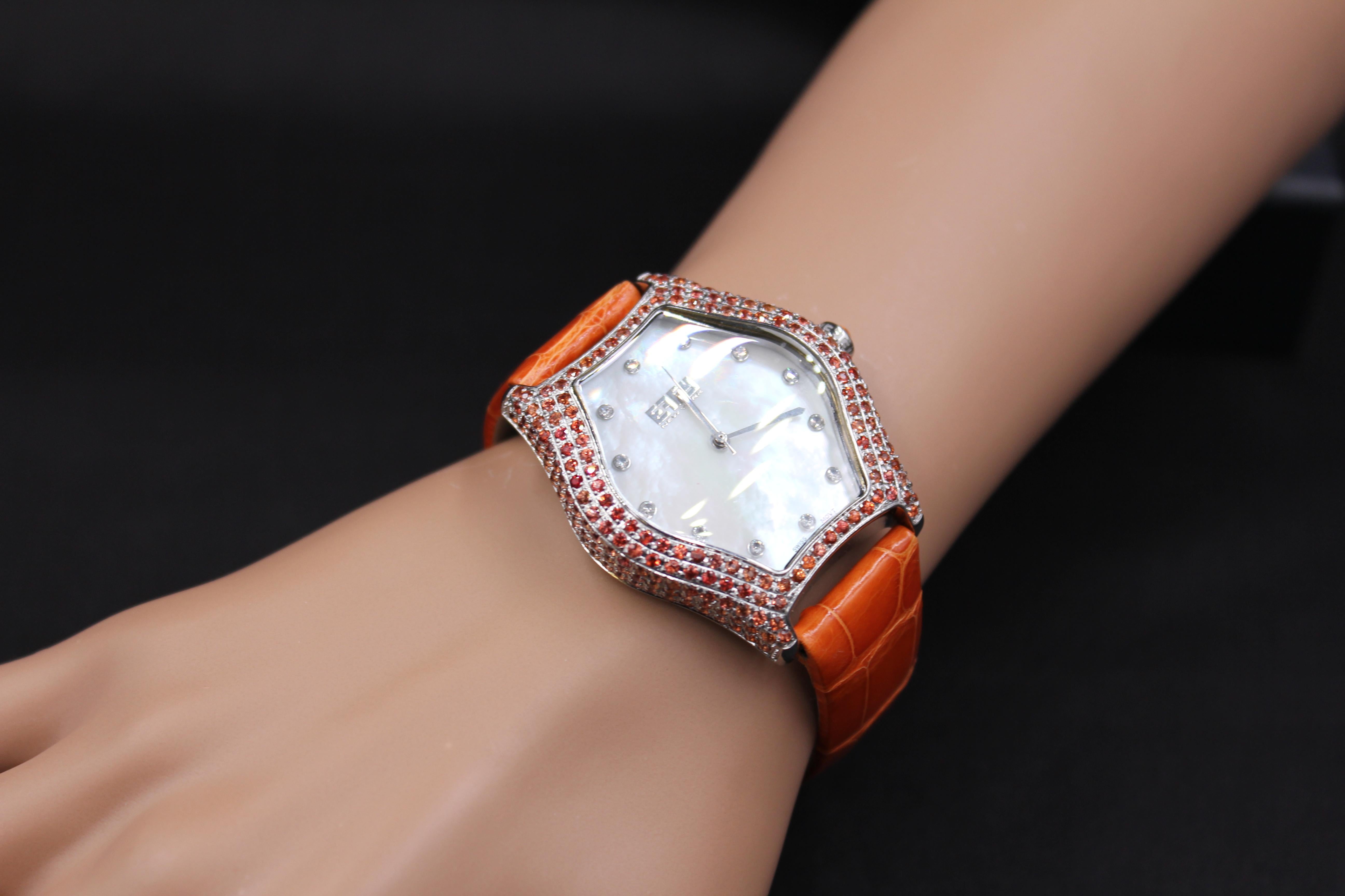 ·      Quality Swiss-Quartz movement guarantees precision timing
·         Mother-of-Pearl dial micro-paved with diamonds and gemstones enhances any dress style
·         Scratch-resistant sapphire glass lens
·         Genuine exotic lizard leather