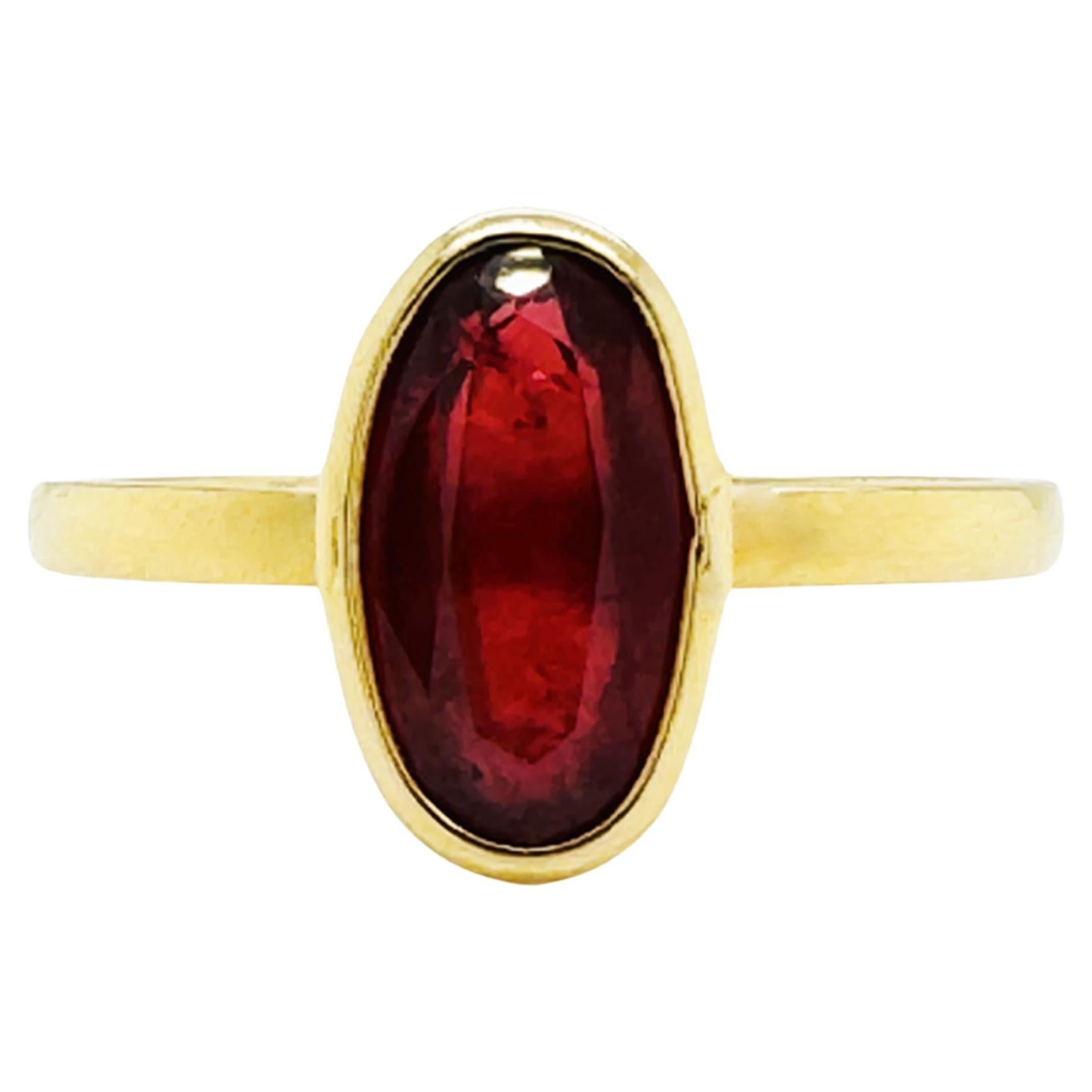 Anello ovale con zaffiro arancione in oro giallo 18 carati