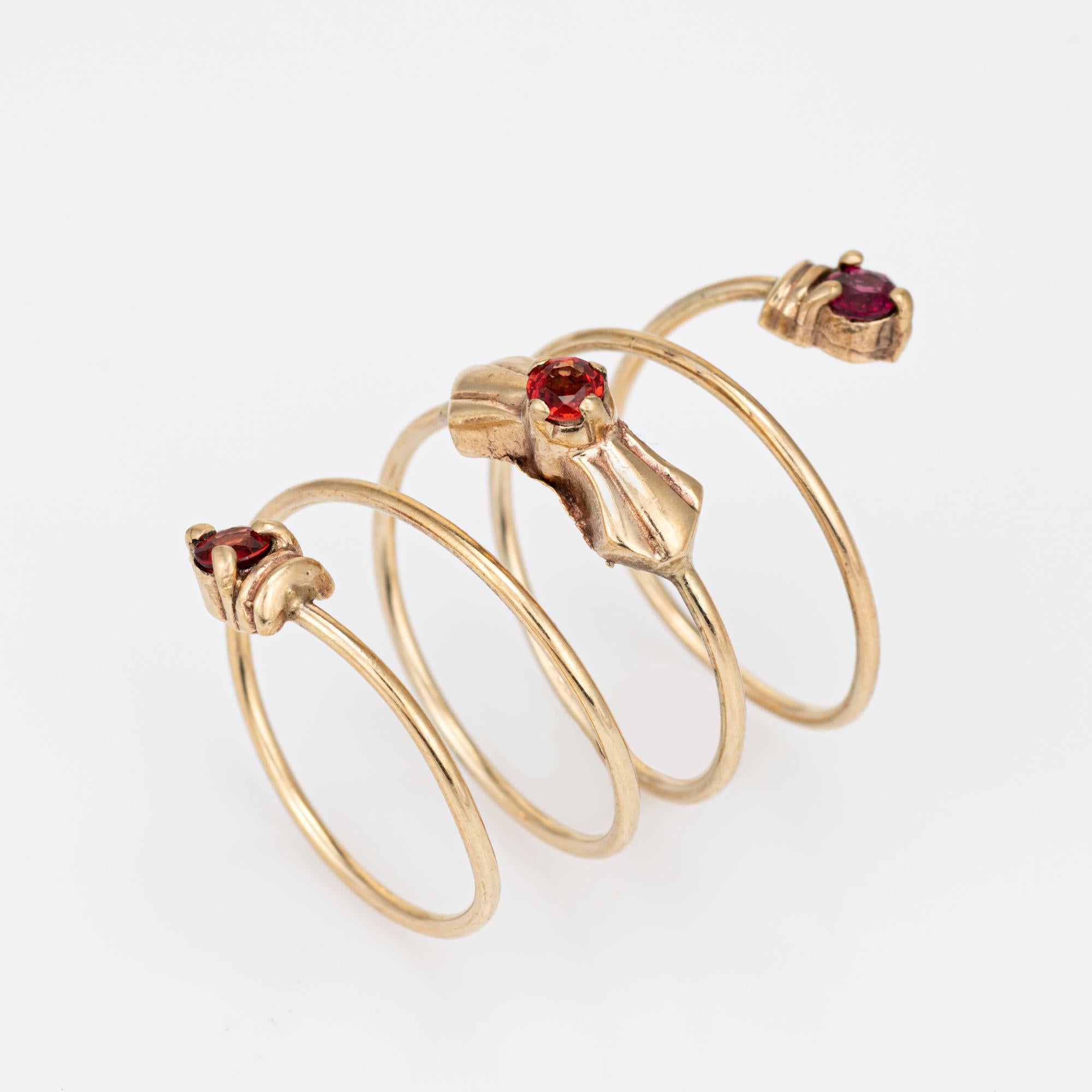 Stylish orange sapphires 'spring' ring crafted in 10 karat yellow gold. 

Three orange sapphires measure approx. 3.5mm each. The sapphires are in very good condition and free of cracks or chips. 

The ring coils around the finger five times,